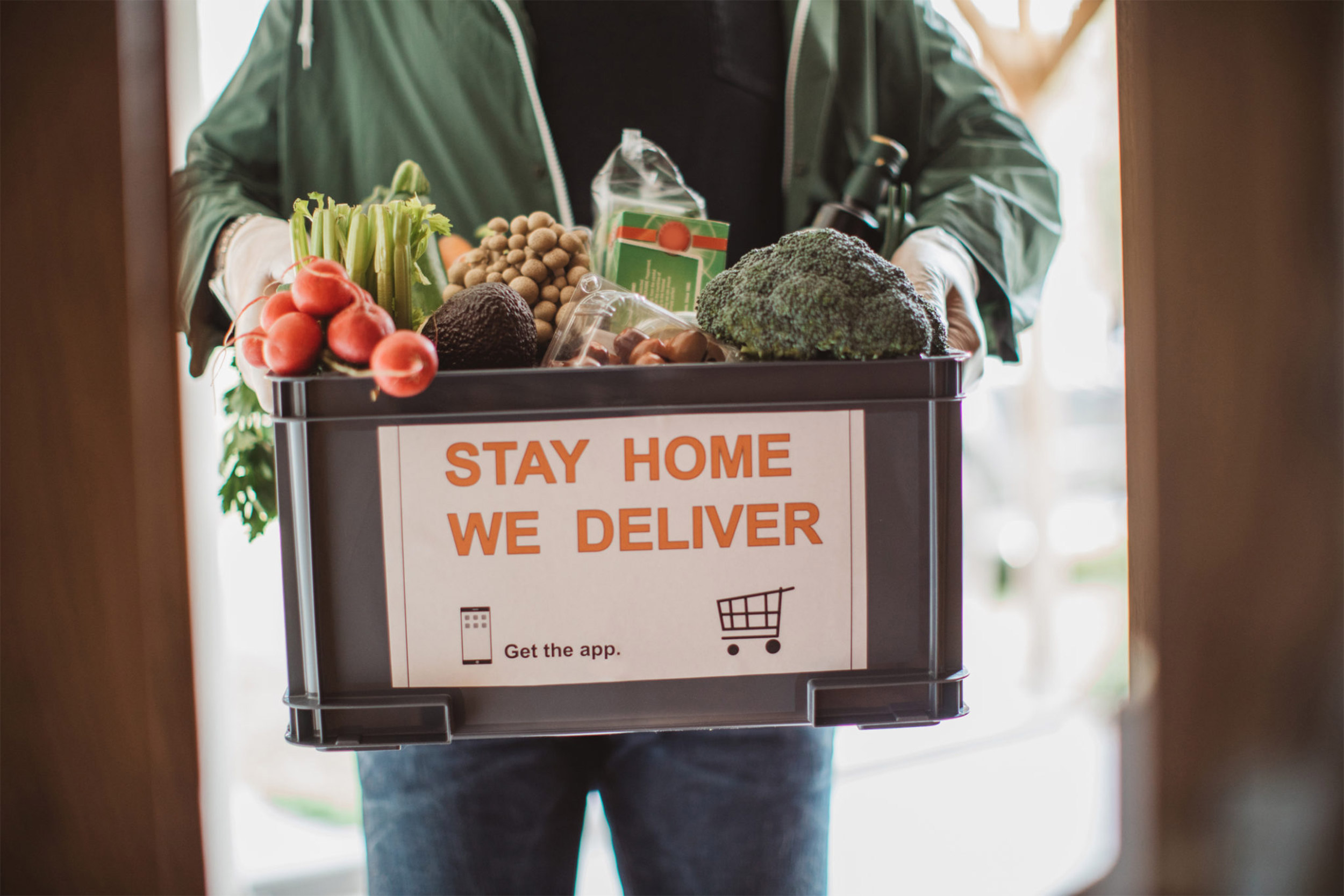 Man holding box of food.