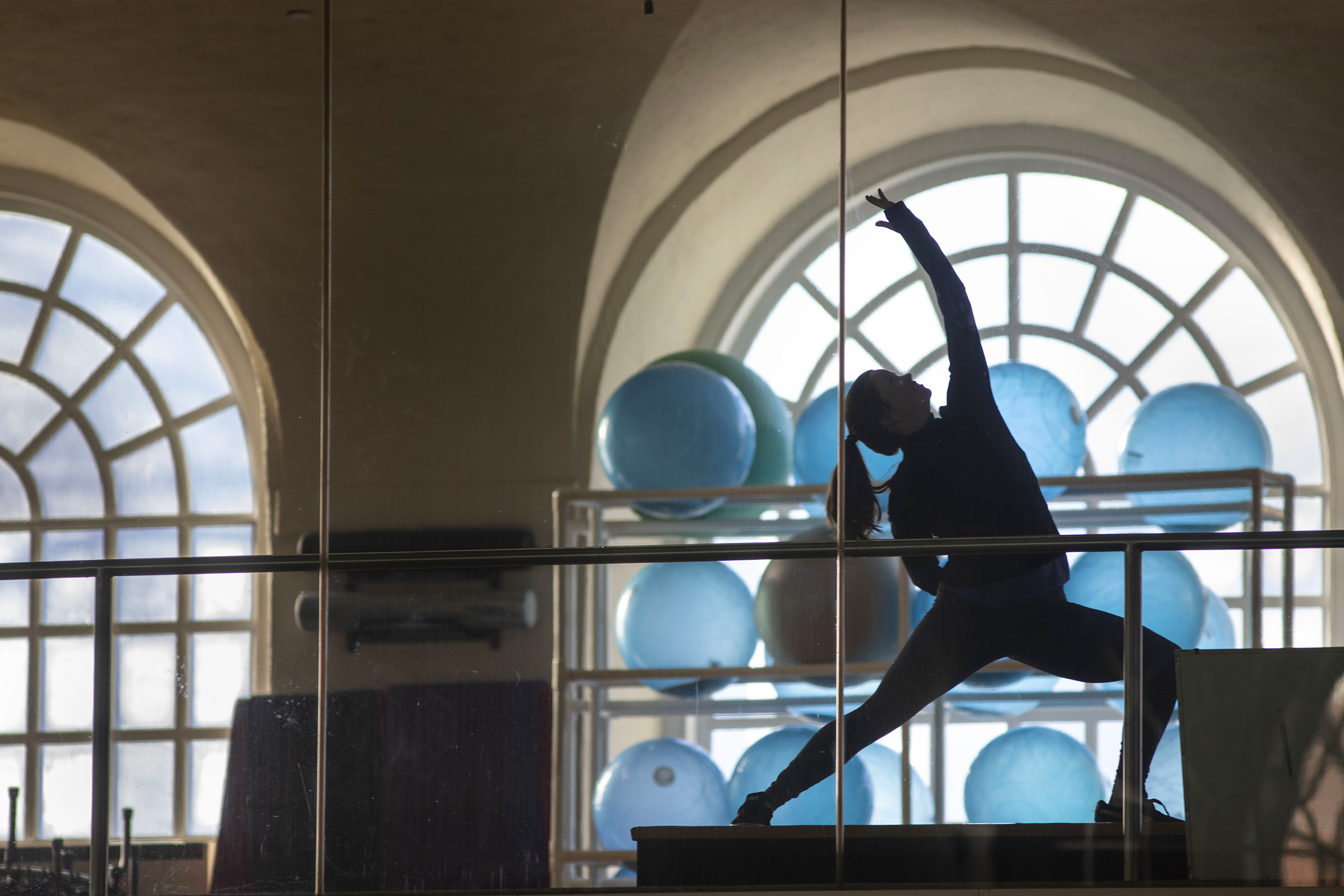 Fitness coordinator Ariel Wahl practices yoga poses inside the Malkin Athletic Center.