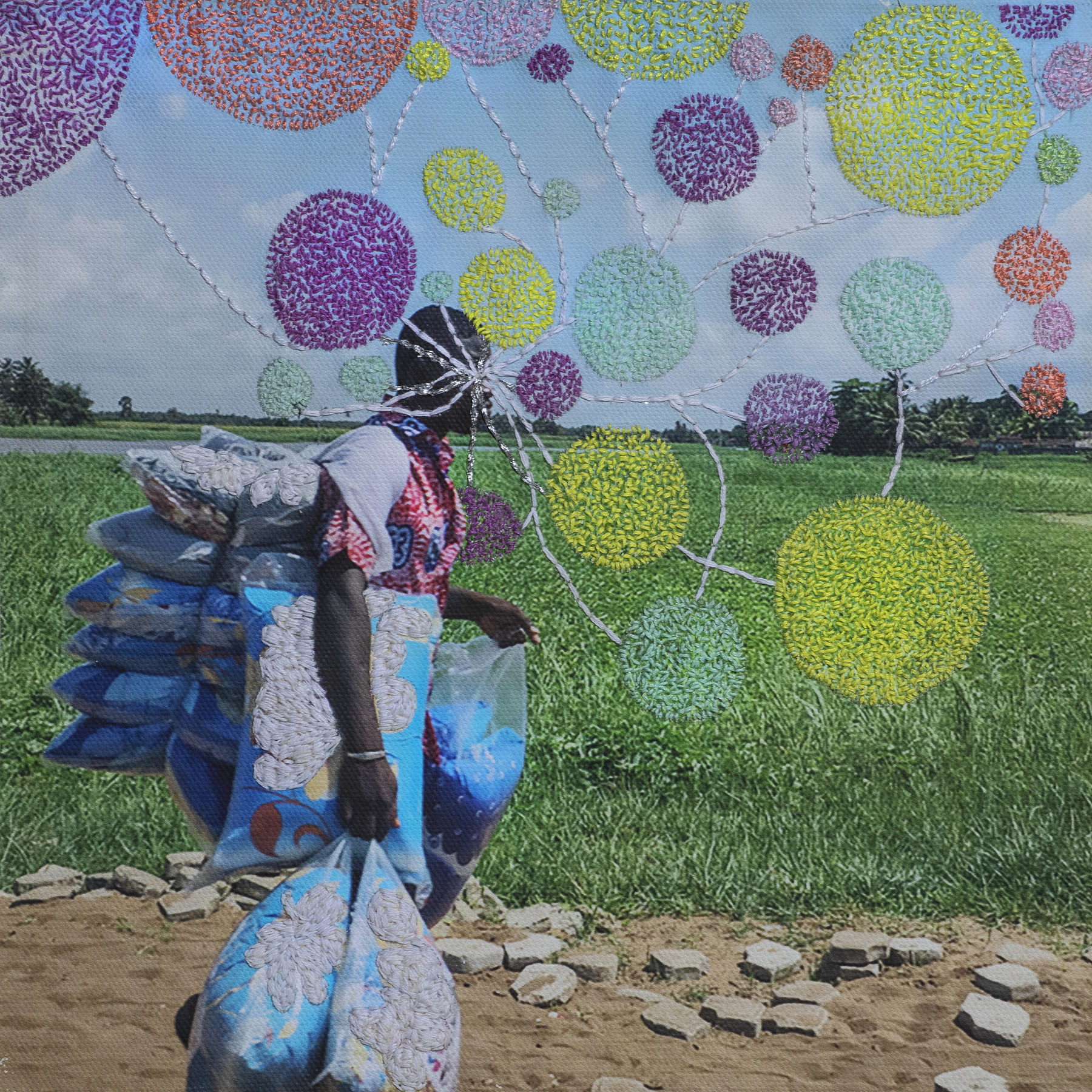 Embroidered photo of a person carrying textiles.