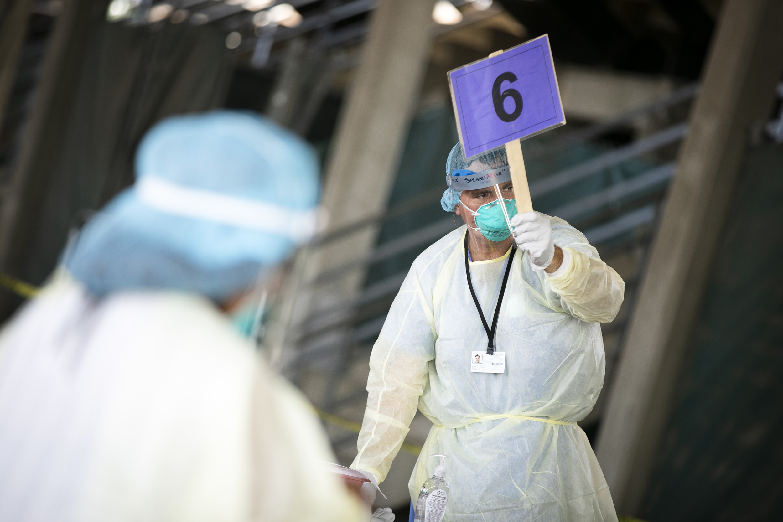 Nurse holds sign during COVID testing.