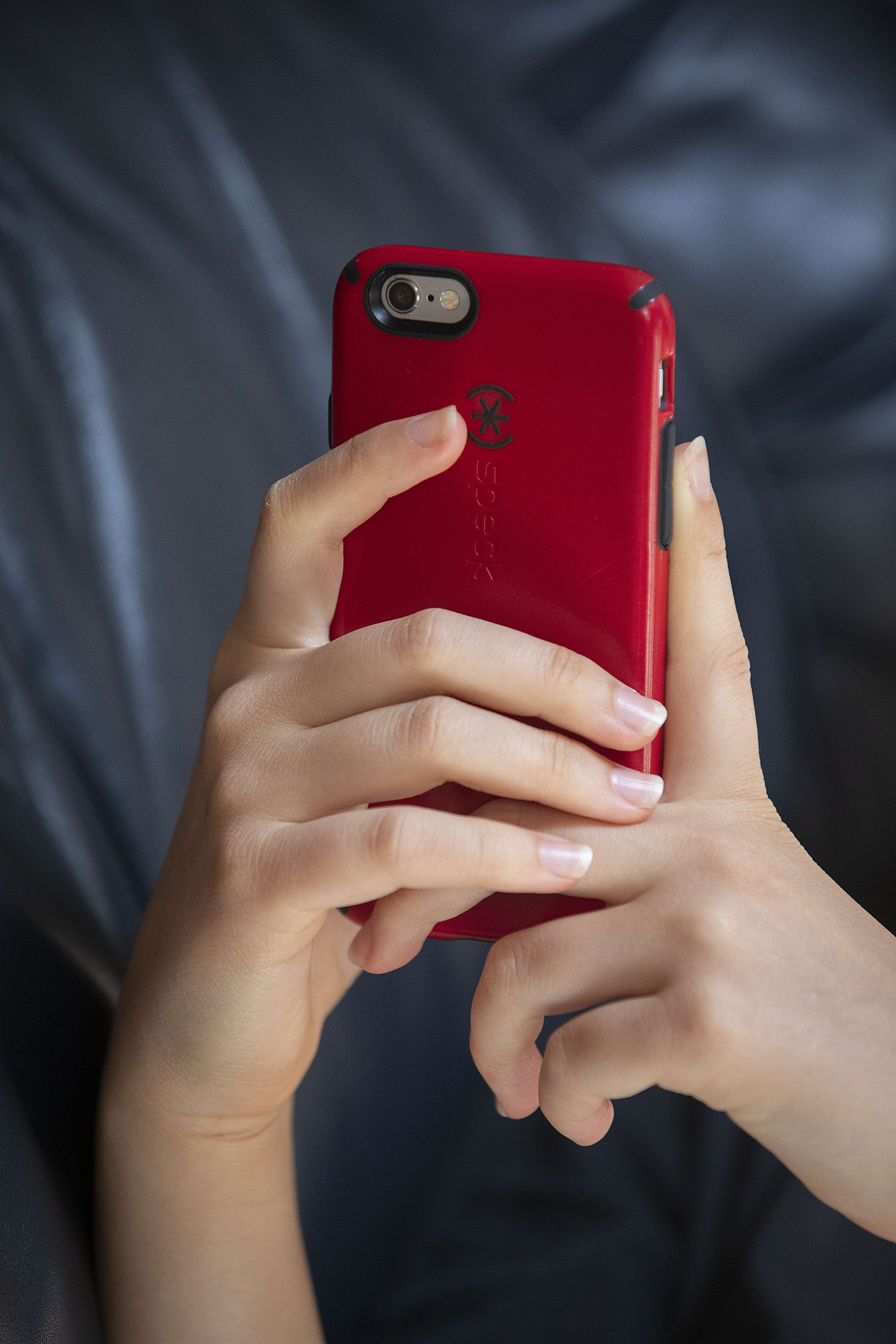 Hands holding a smartphone.