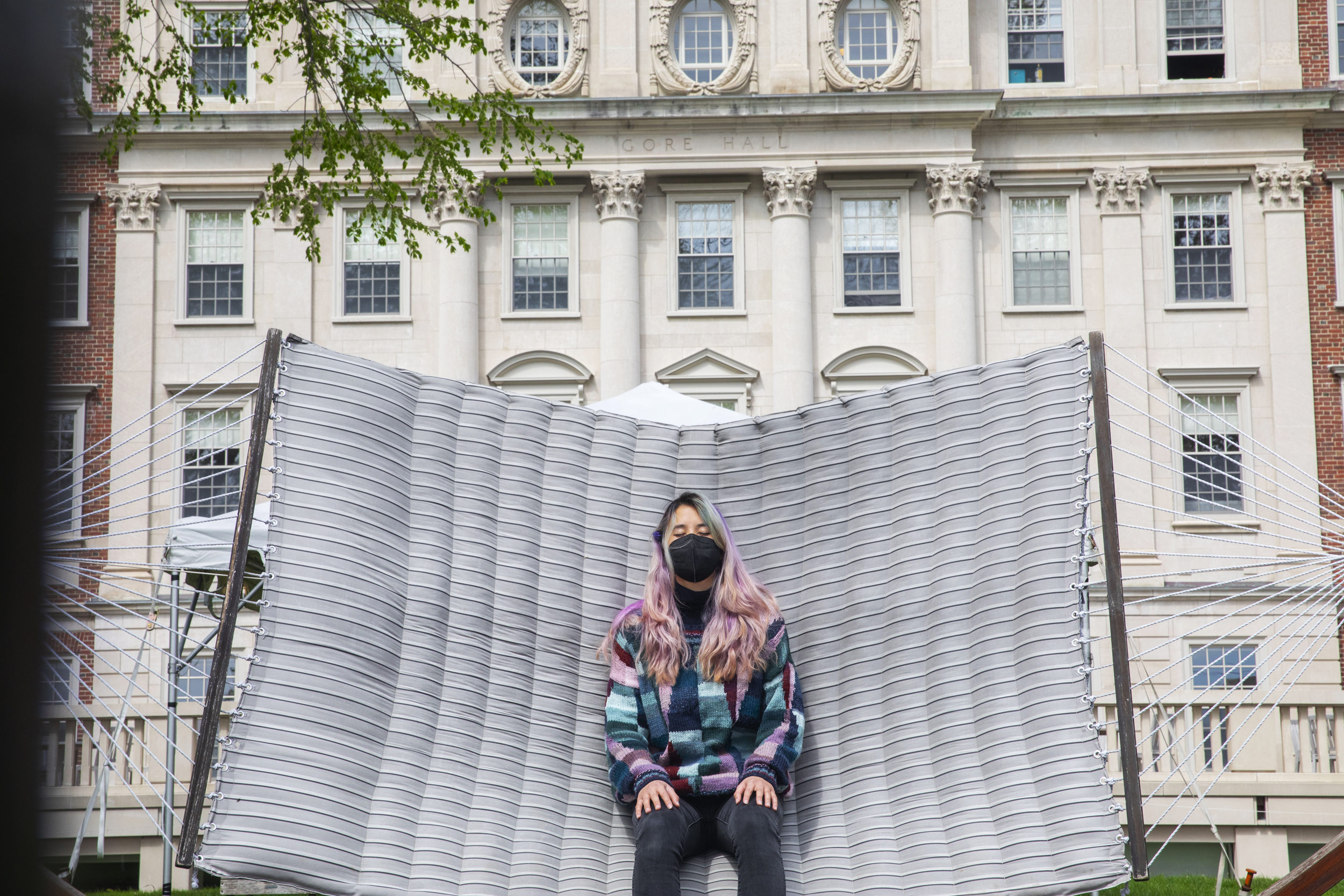 Olivia Tai '21 relaxes on a hammock at Winthrop House while practicing a meditation that involves watching one's breath.