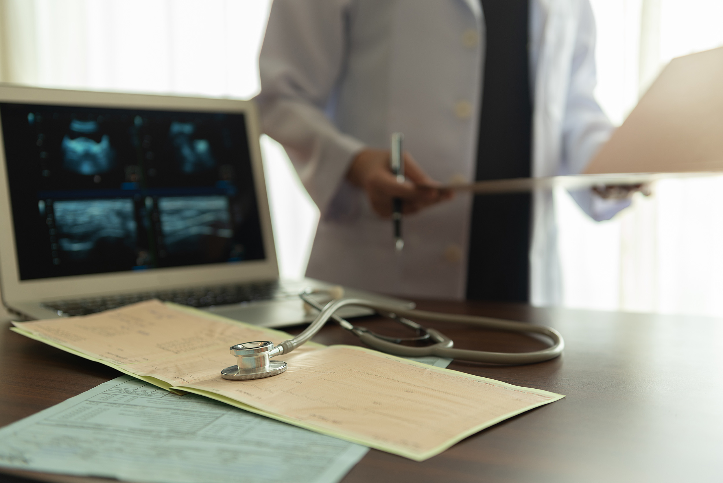 A doctor studying diagnostic data of patient.