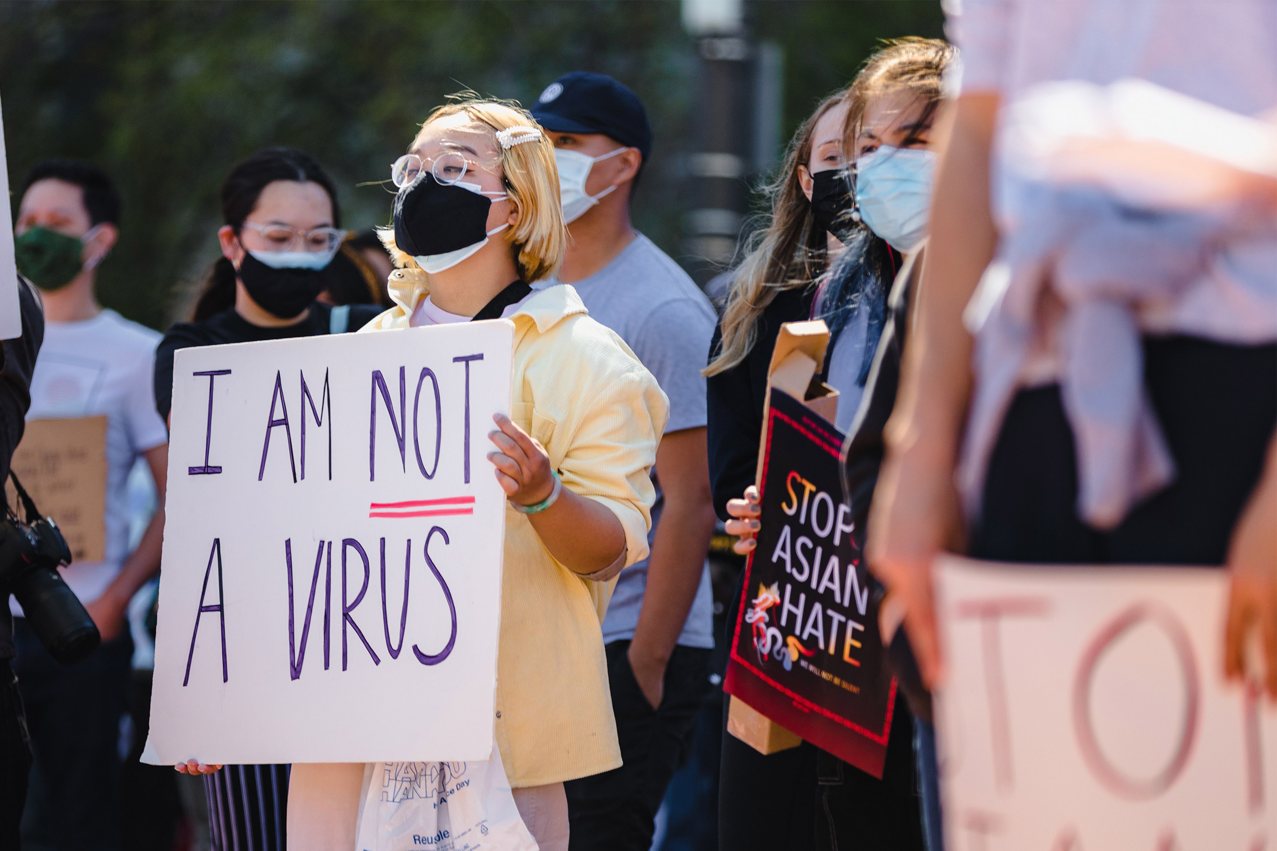 Woman holding I am not a virus sign.