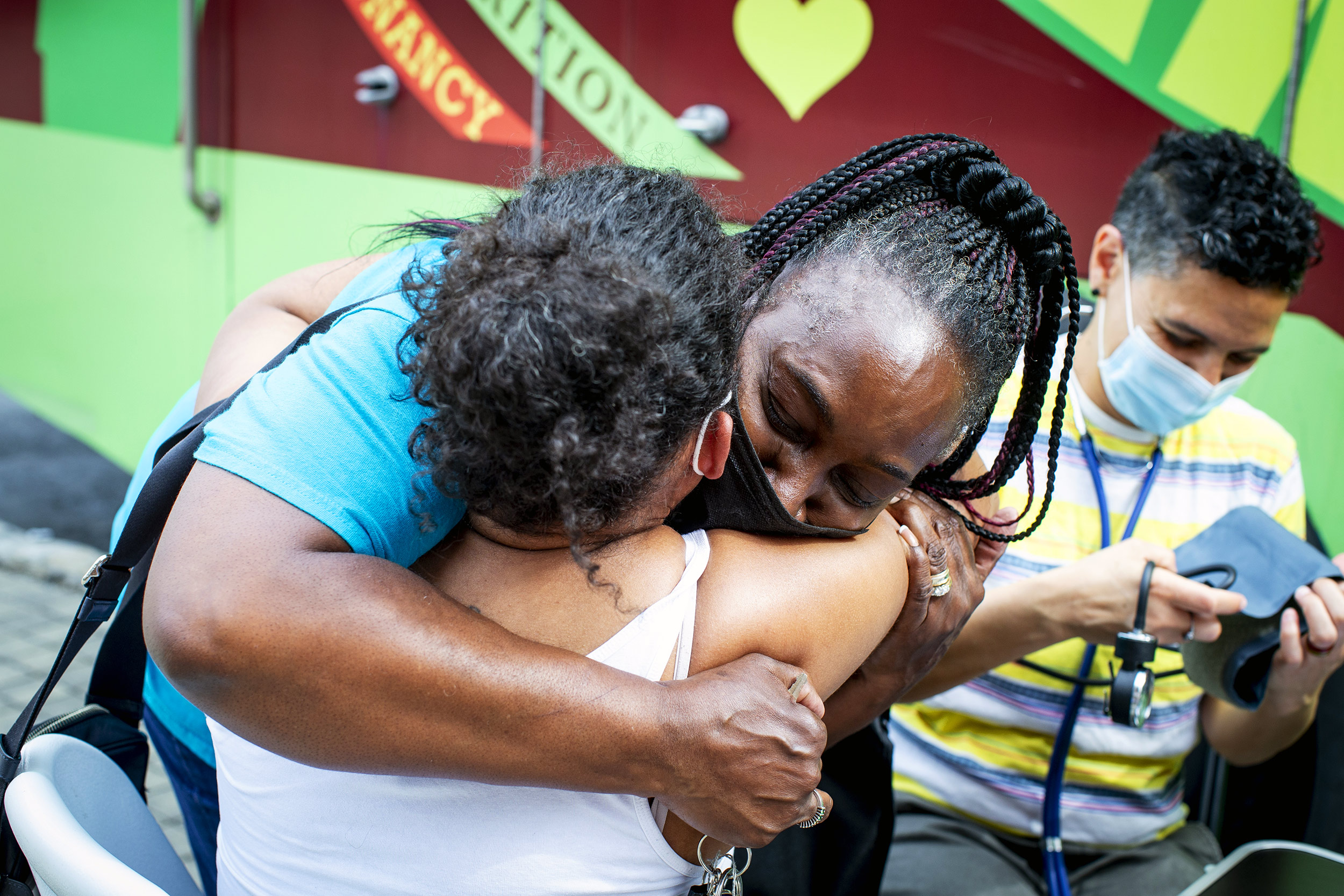 Assistant Director, Rainelle Walker White (facing camera) heartily greets fellow staffer, Joanne Suarez at Harvard University's Family Van.