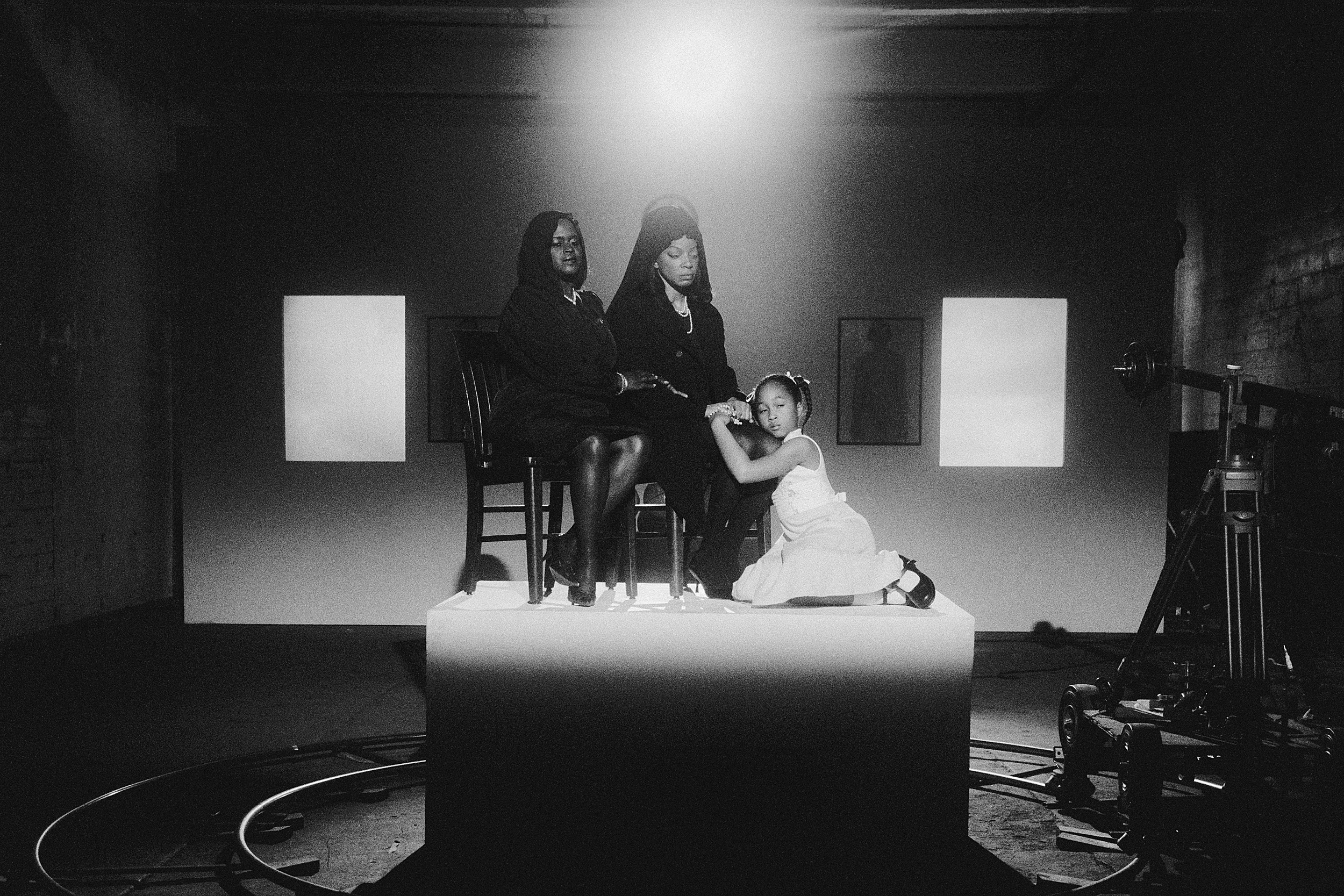 Two women and a girl in mourning.