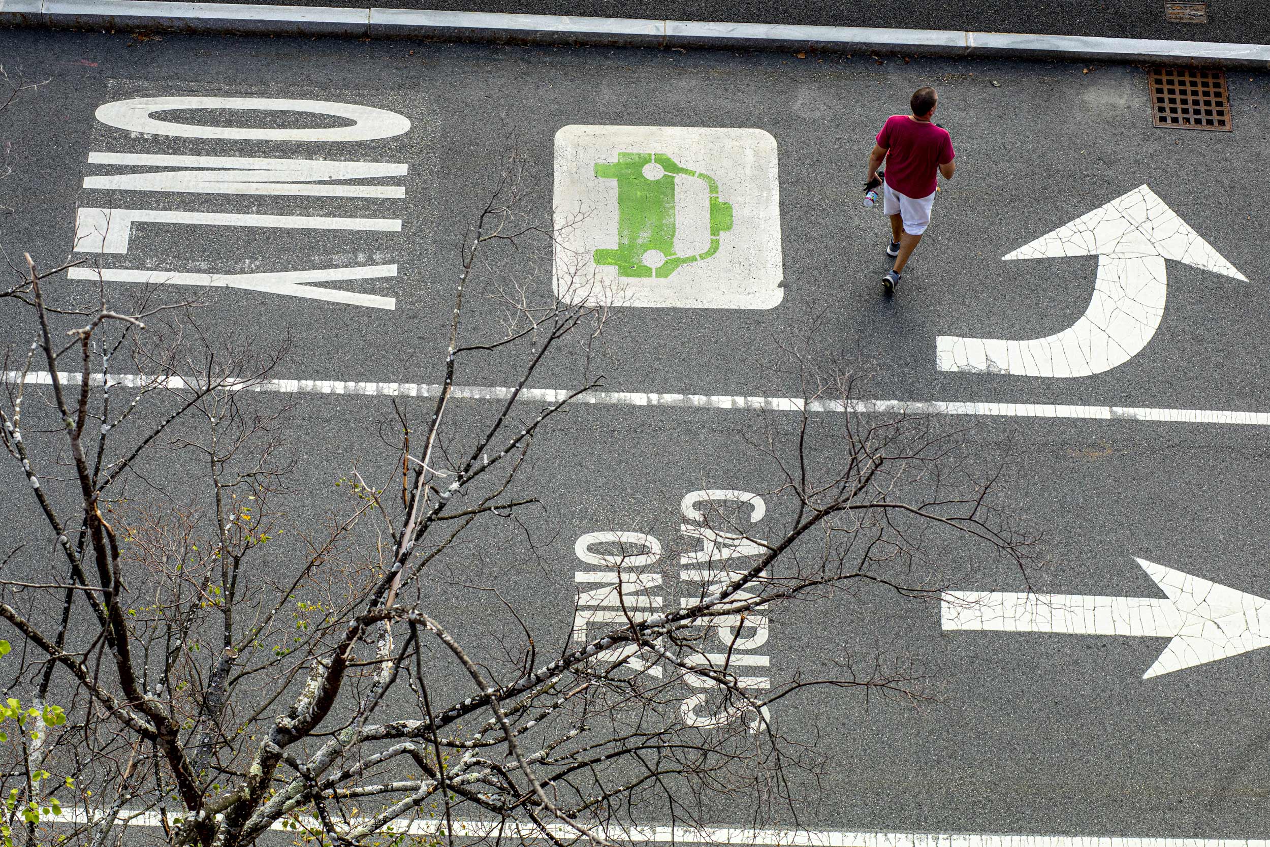 A pedestrian follows the arrow outside Soldiers Field Garage at Harvard Business School.