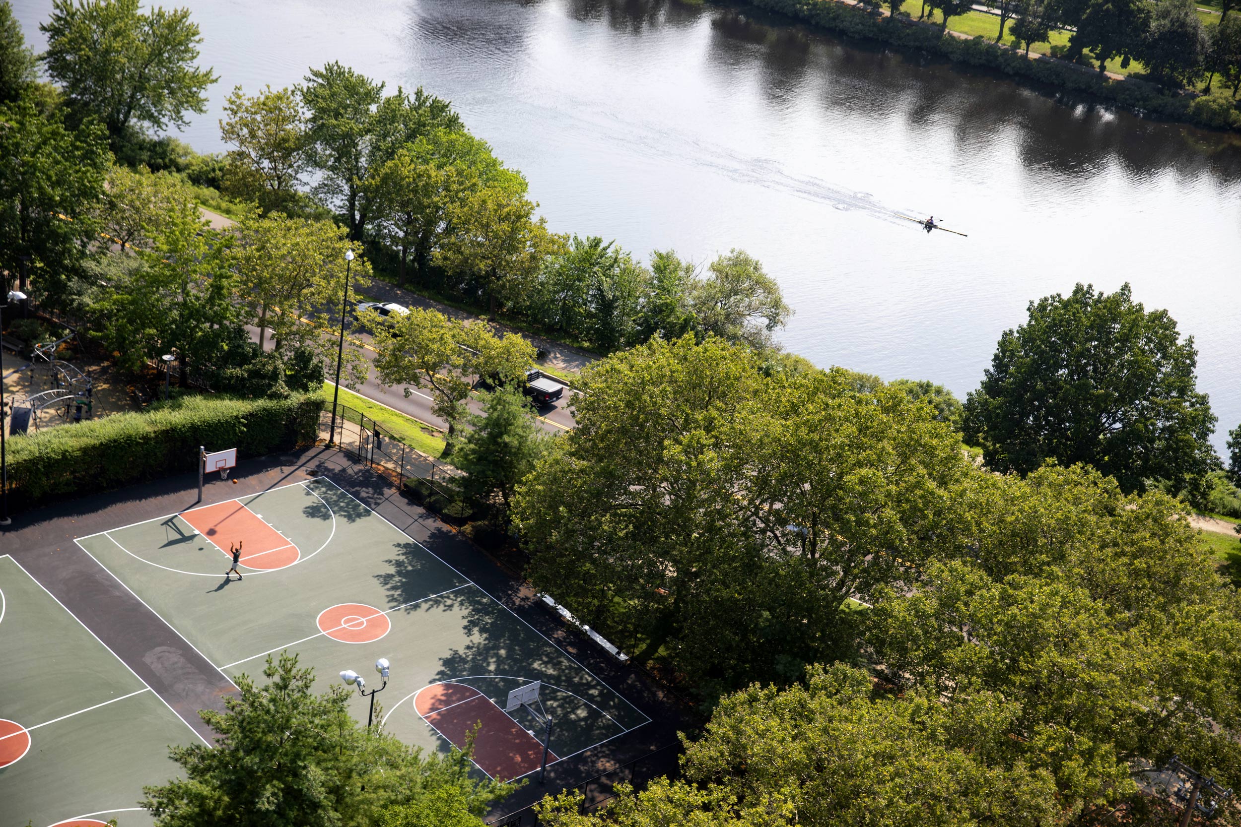 A solitary basketball player and rower are pictured from above.