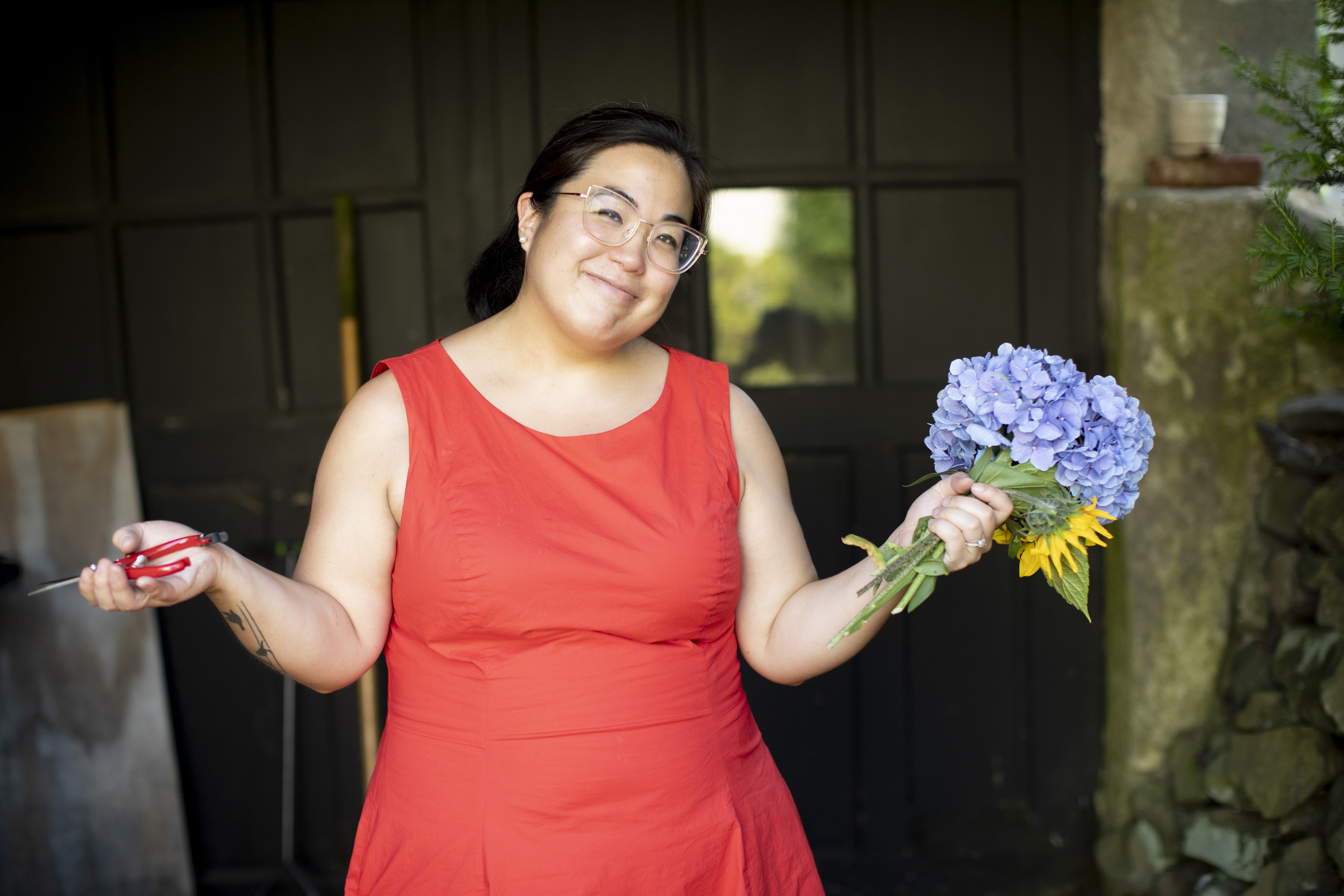 Margaret Okada-Scheck holds freshly cut flowers at her Waltham home where she started gardening during COVID 19.