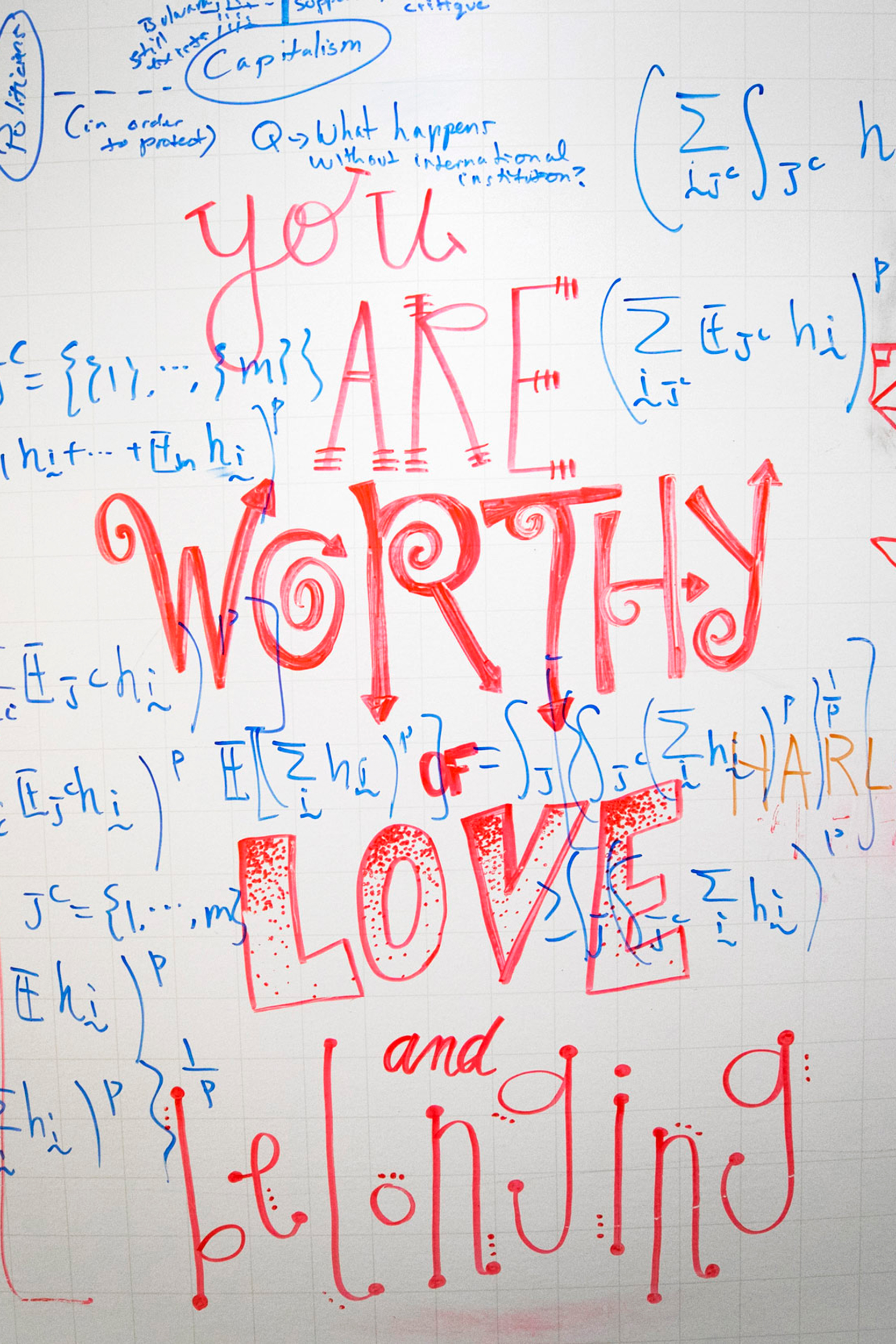 "You are worthy of love and belonging," says whiteboard covered in colorful messages in halls of Institute for Quantitative Social Science.