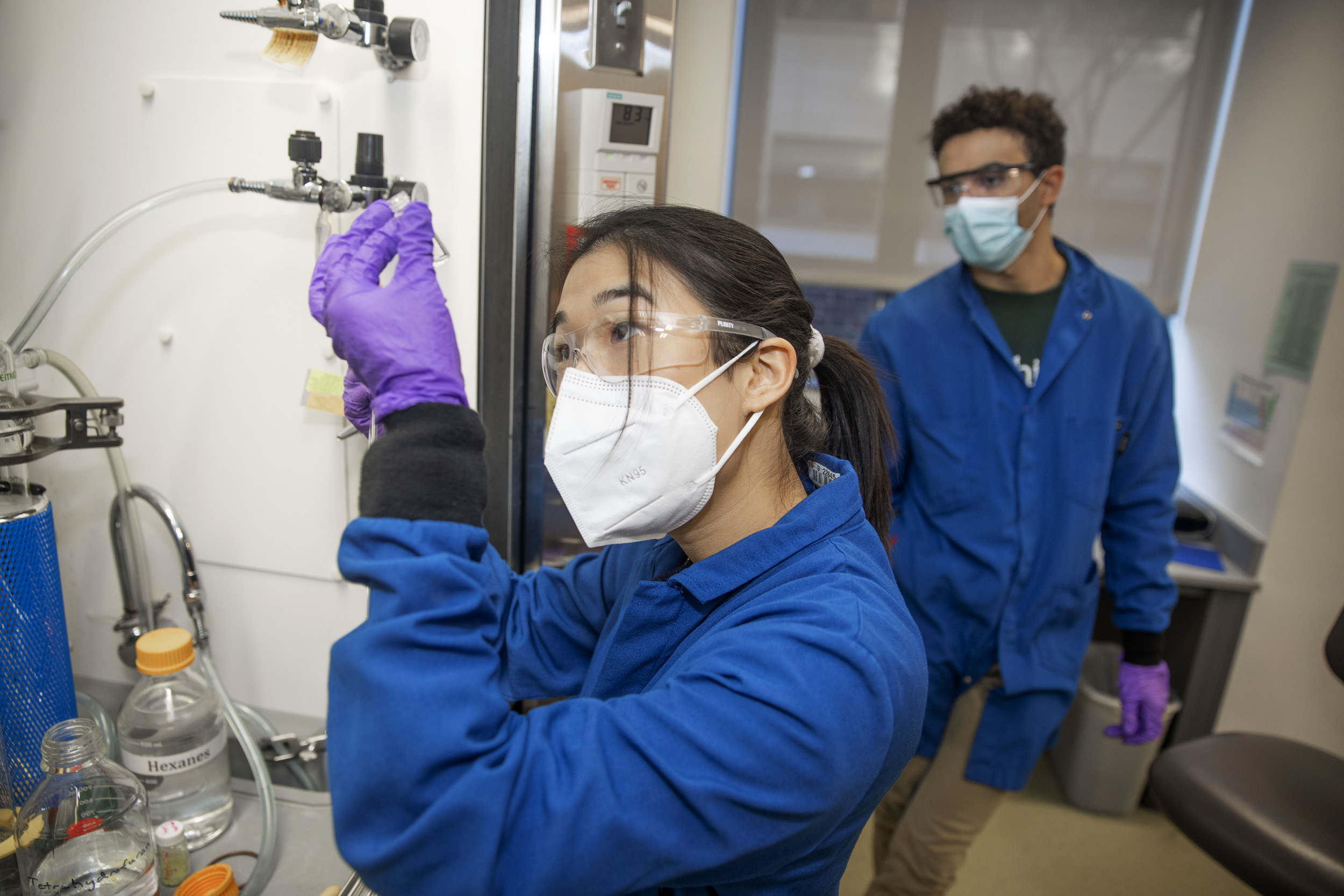 Christie Hung ’23 and GSAS student Brandon Campbell practice distilling in the Northwest Building.