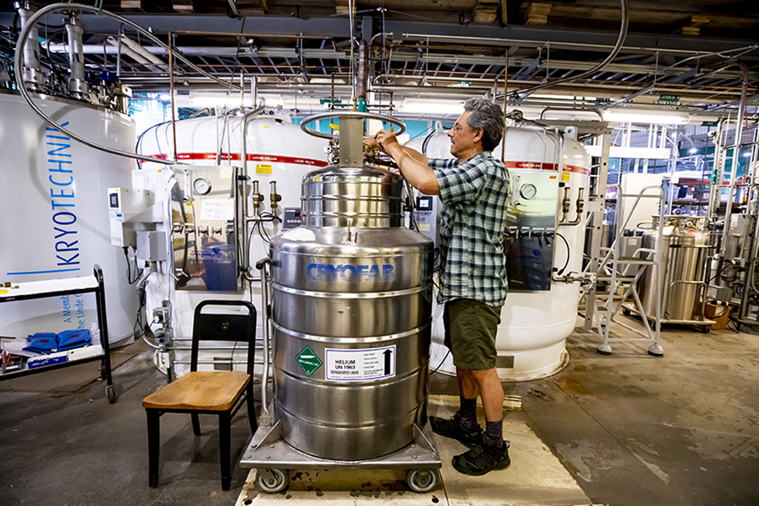 Markos Hankin fills helium tanks at the Helium Recovery Facility at Harvard.