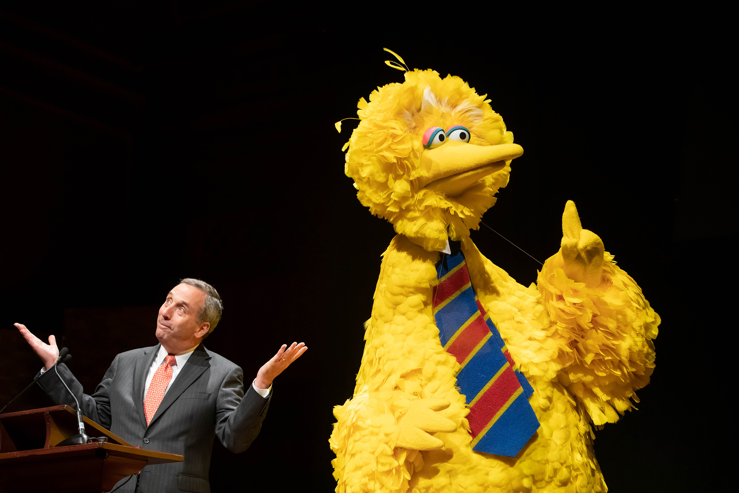 Larry Bacow with Big Bird at Sesame Street 50th anniversary celebration.