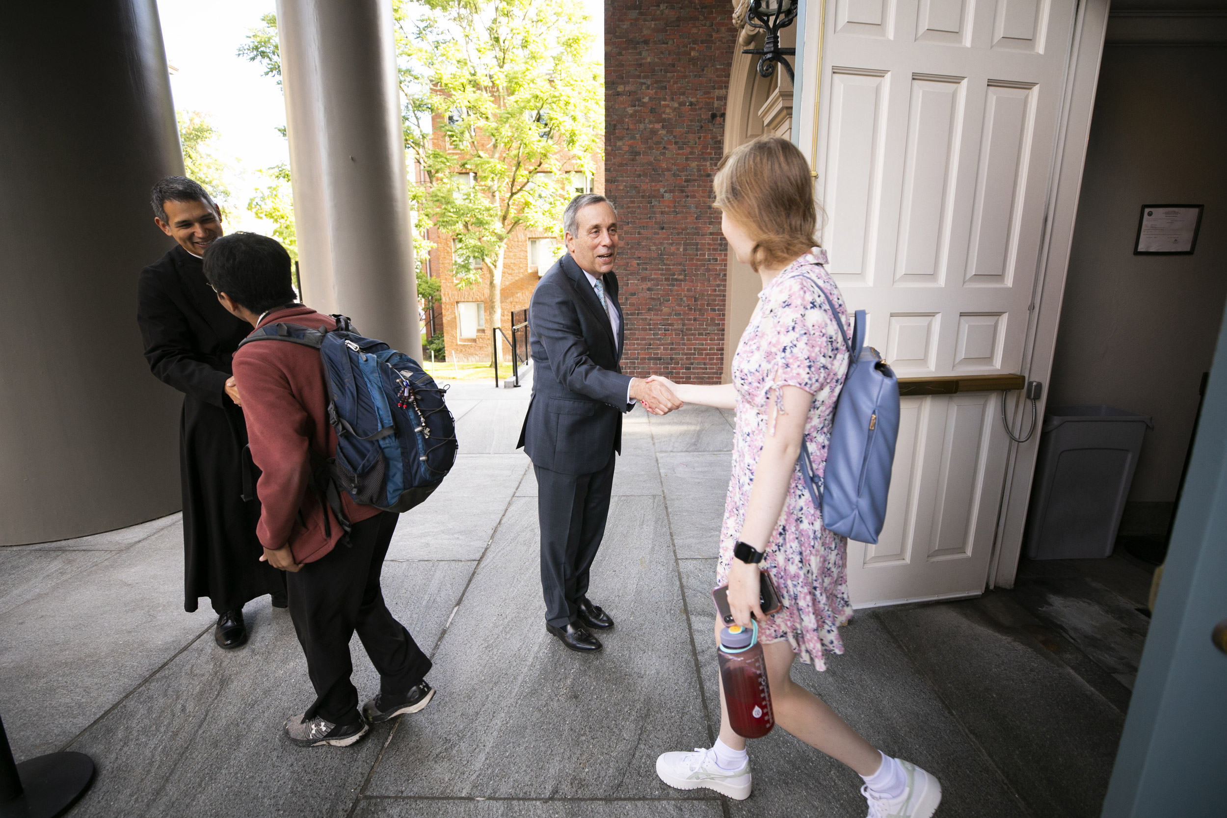 Rev. Potts and Larry Bacow greeting people outside the church.