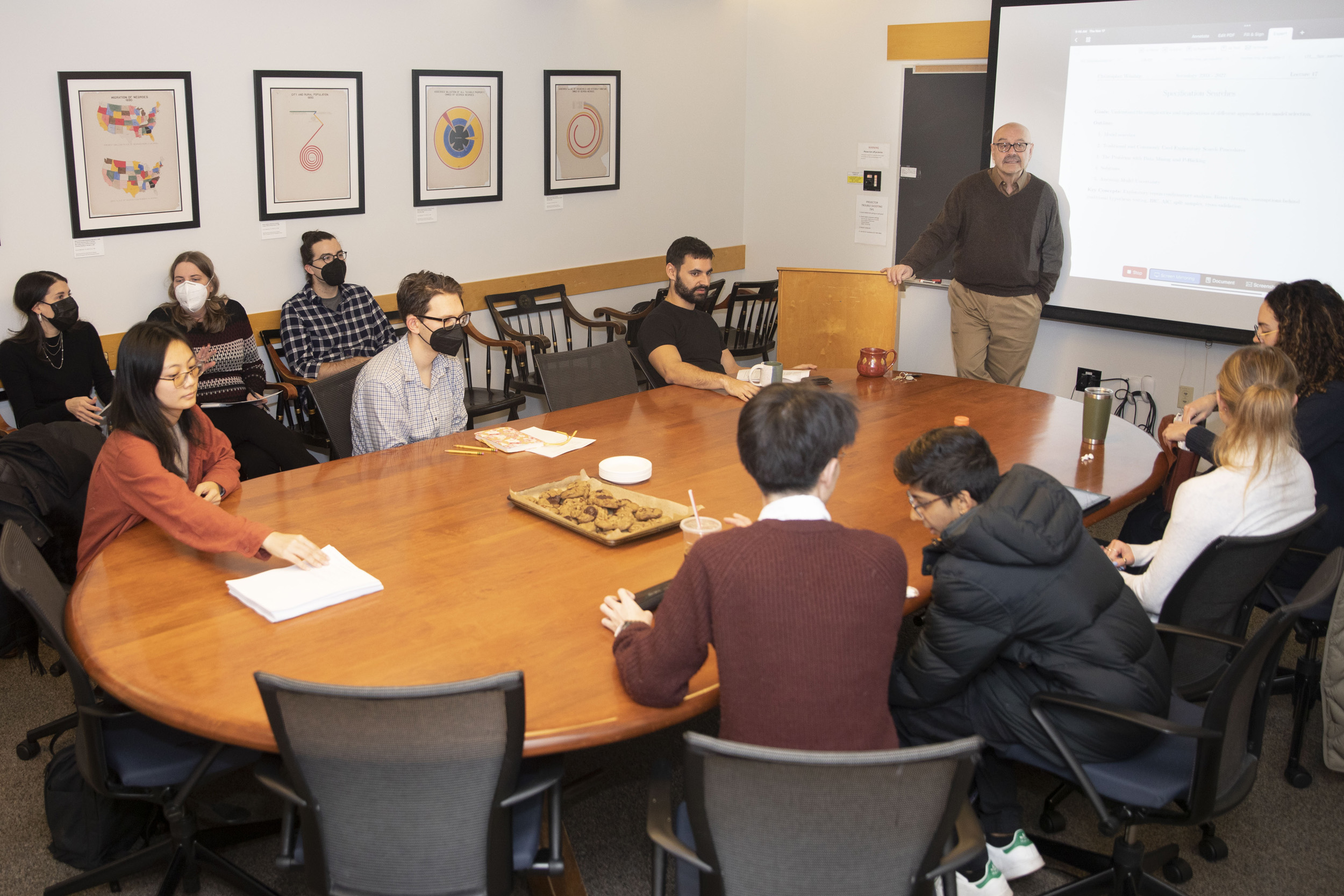 Students sit around table for Professor Chris Winship's last class.