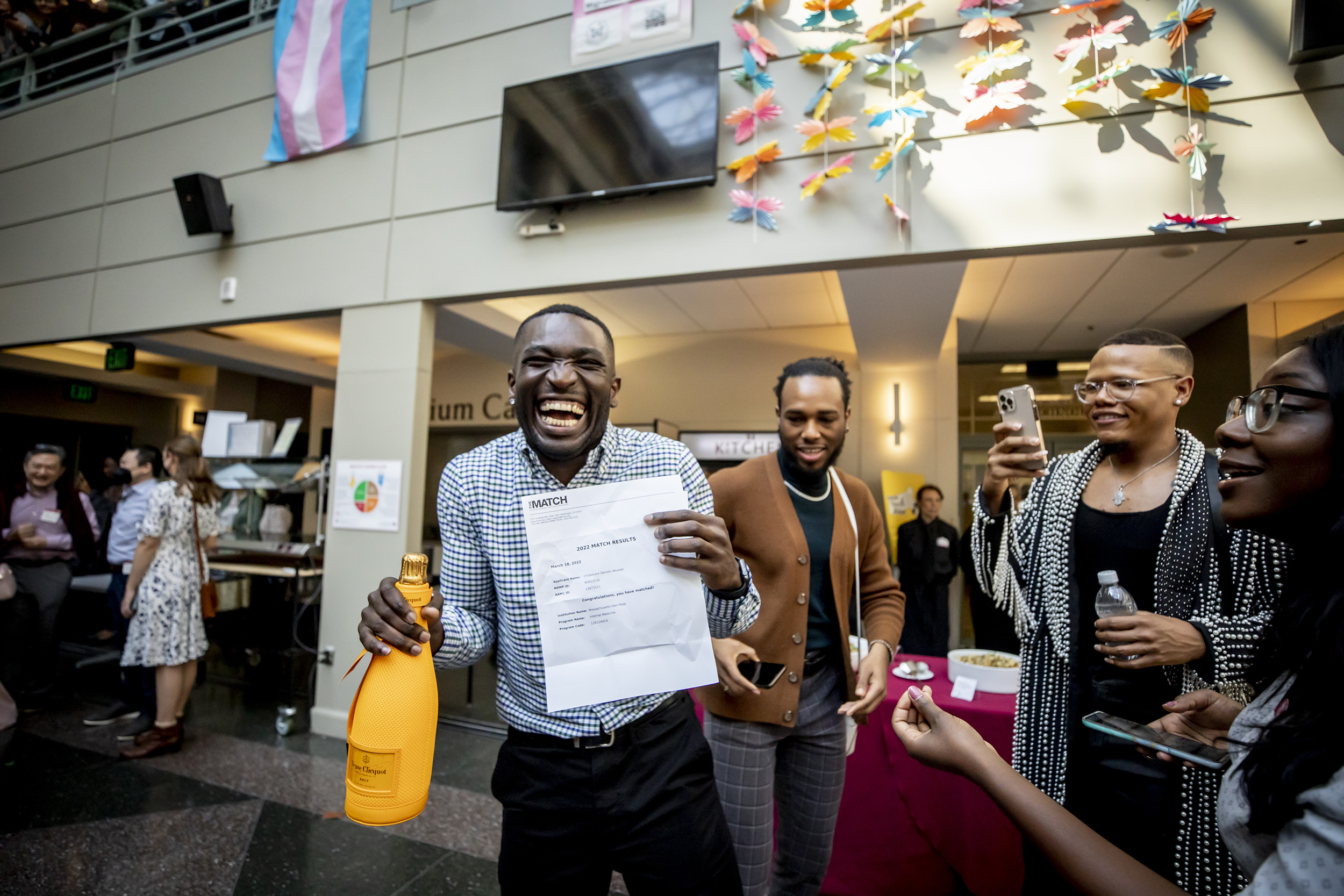 Chidiebere Akusobi holds bottle of champagne on Match Day at Harvard Medical School.