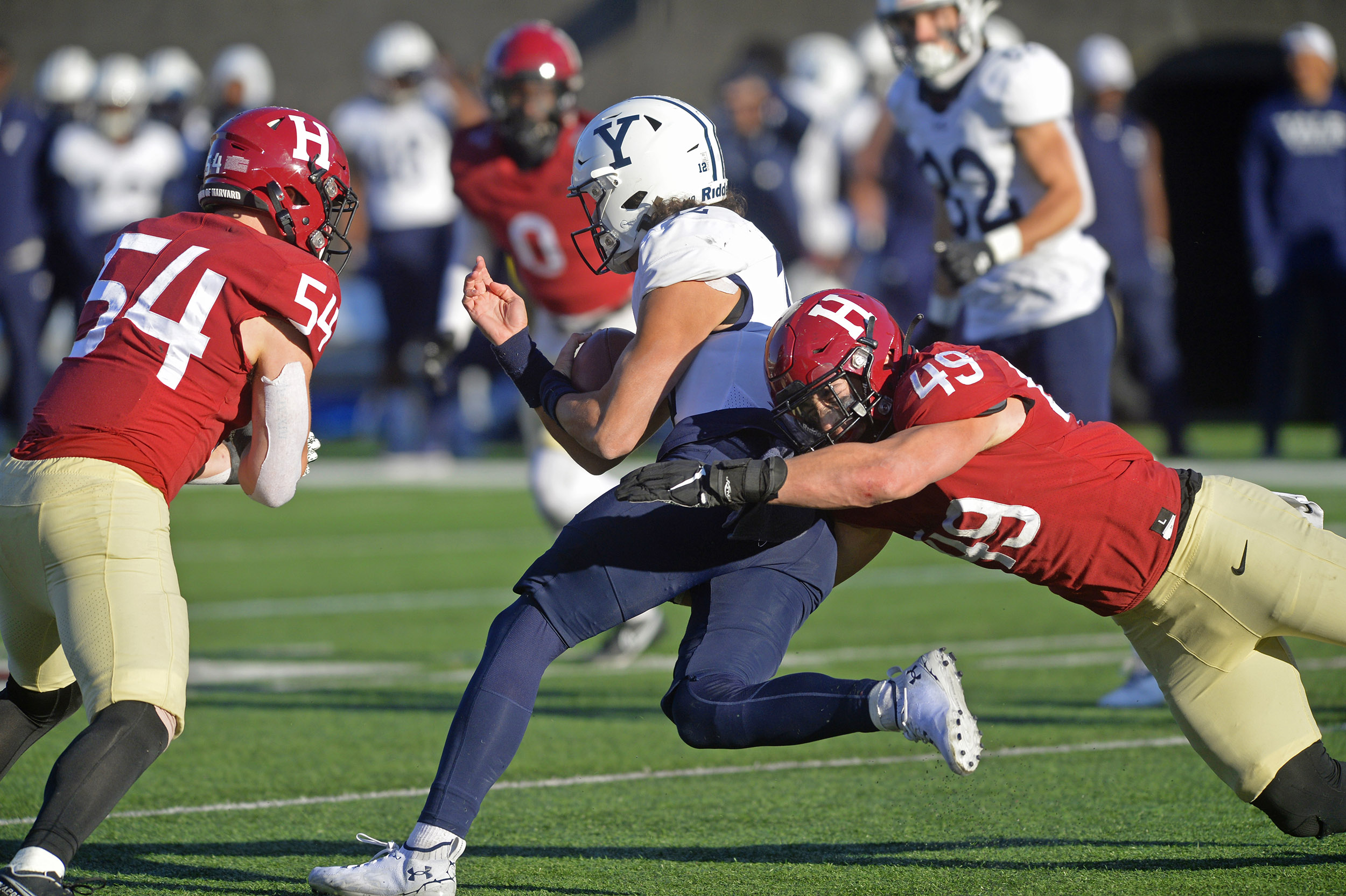 Harvard linebackers trap Yale quarterback in Nov. 9, 2002, football game at Harvard Stadium.