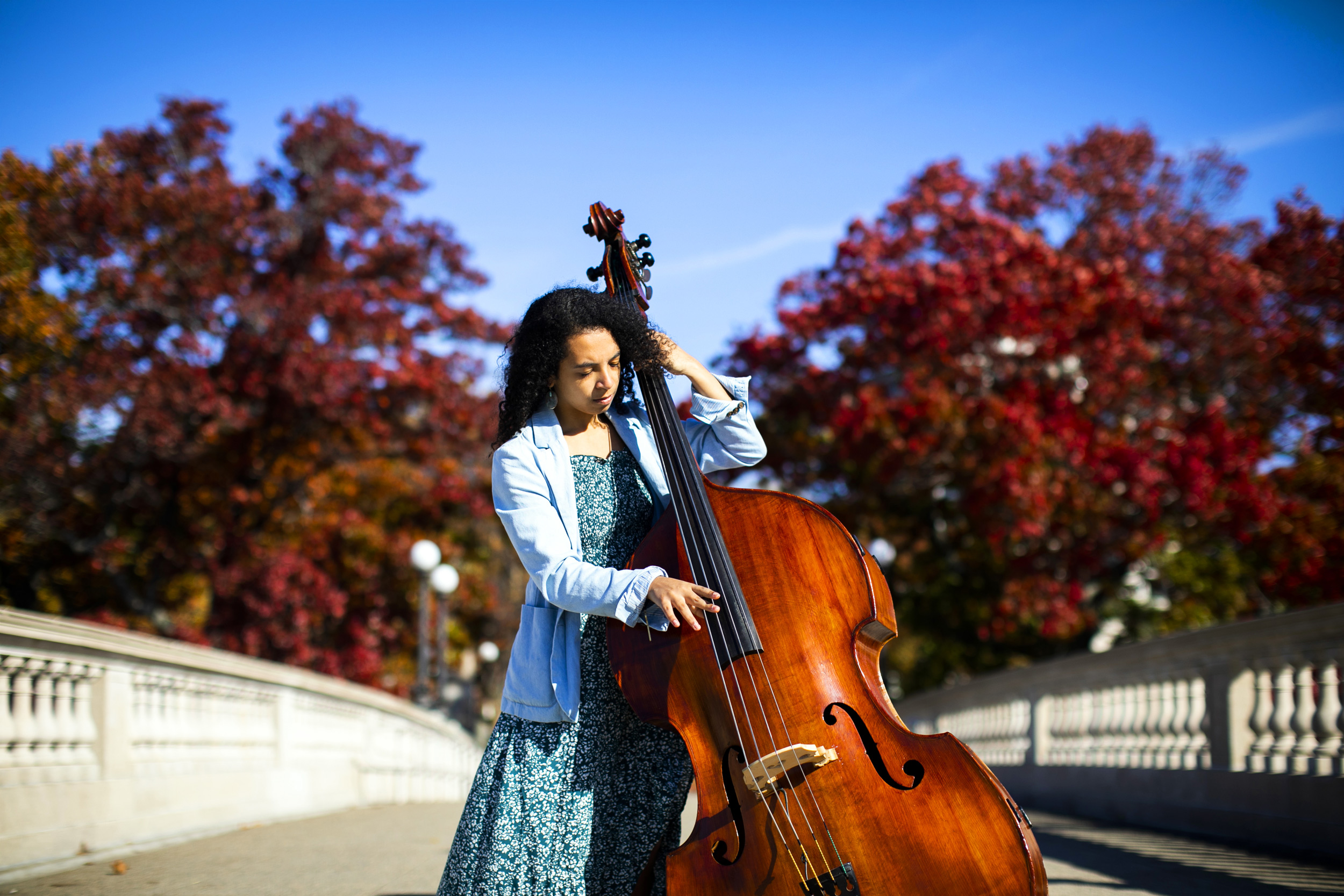 Student Devon Gates plays stand-up bass on Weeks Footbridge at Harvard.