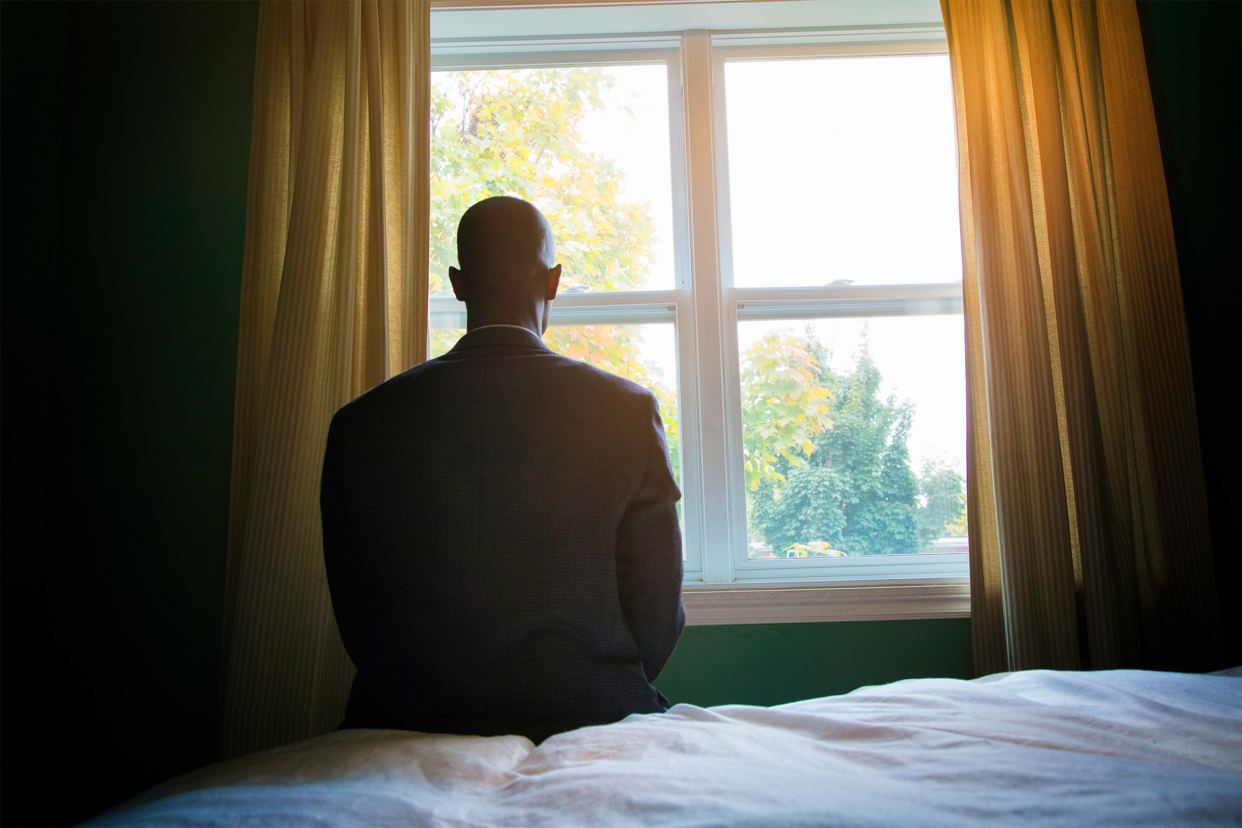 Man sitting on bed.