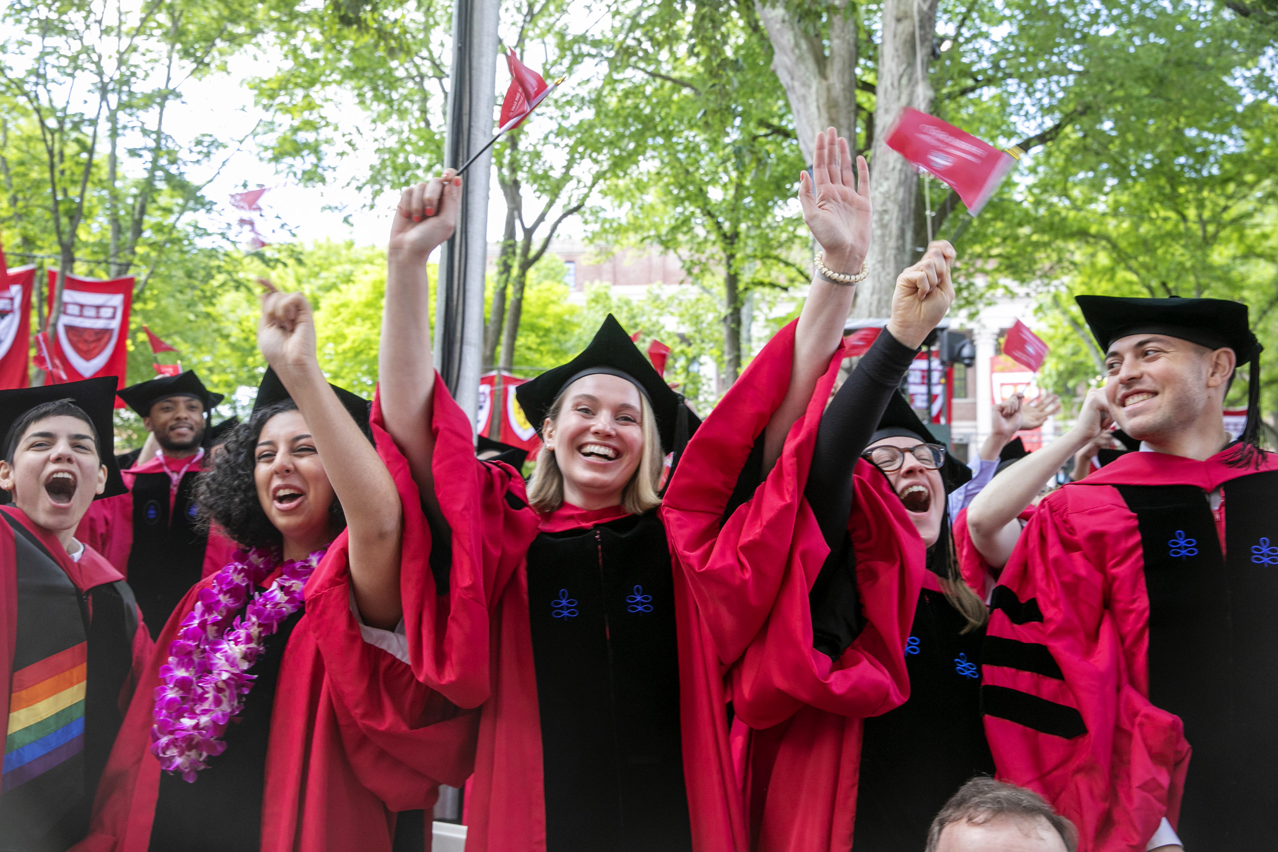 Graduates wave flags.