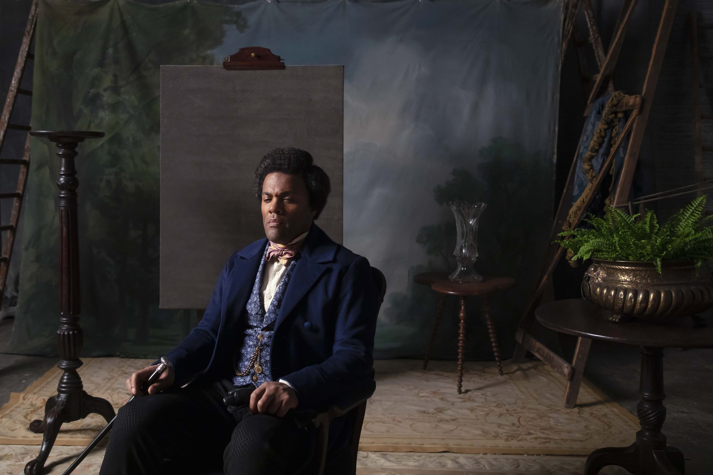 Frederick Douglass sits in photo studio chair in Isaac Julien's "Lessons of the Hour."