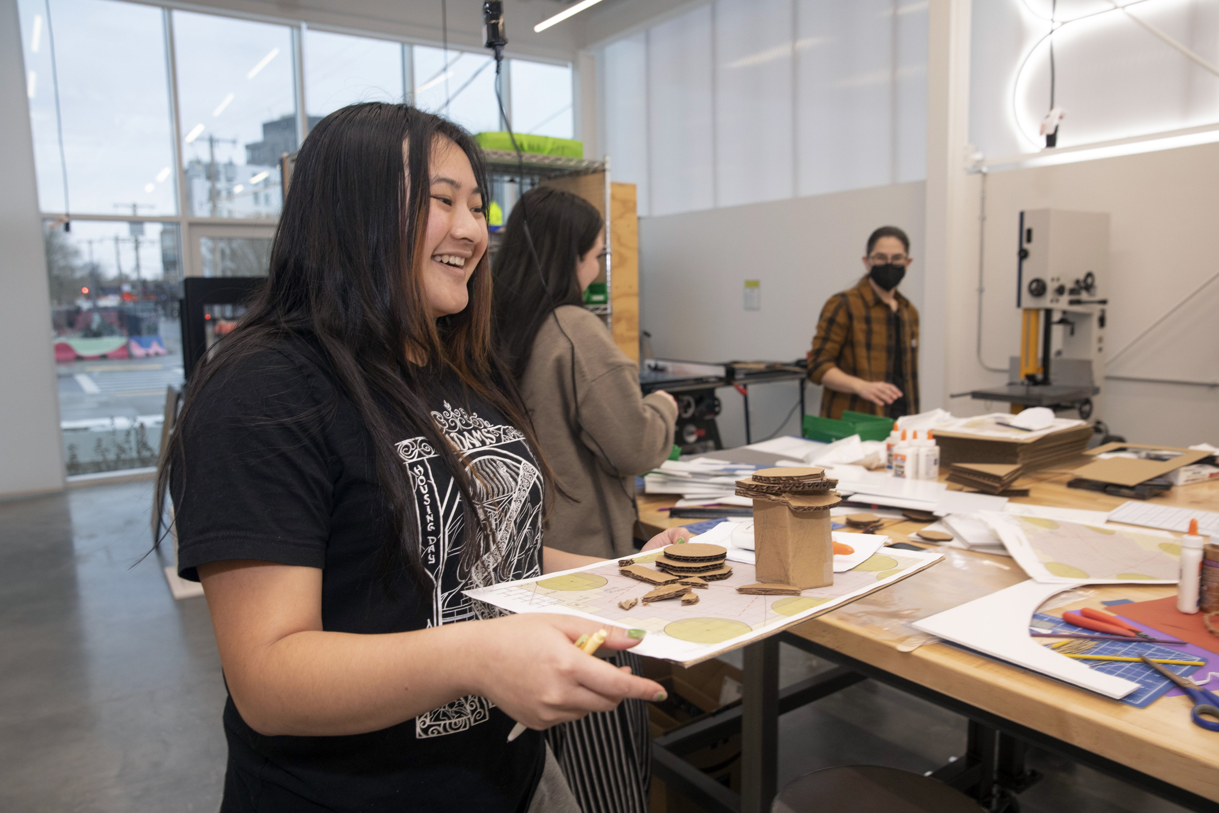 Priscilla Cheav ’25 works on a city planning model.