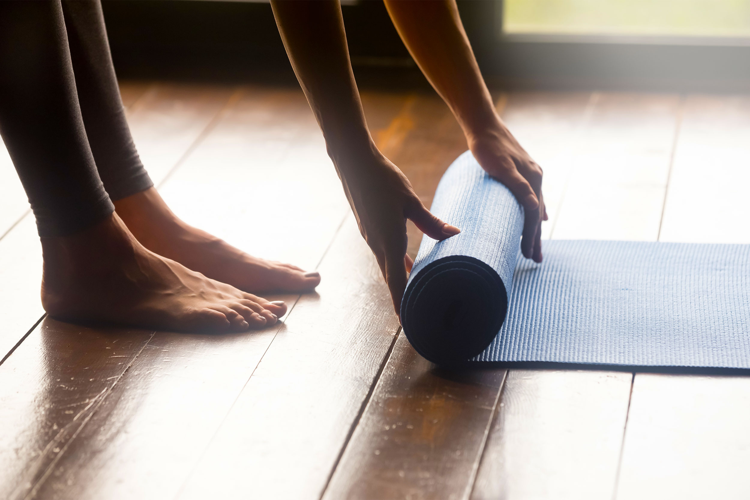 Woman unrolling mat.