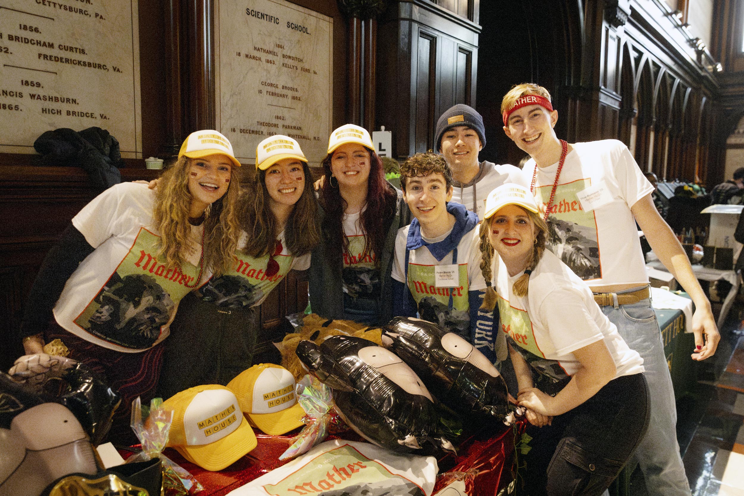 Mather House members pose for a photo in front of their table.