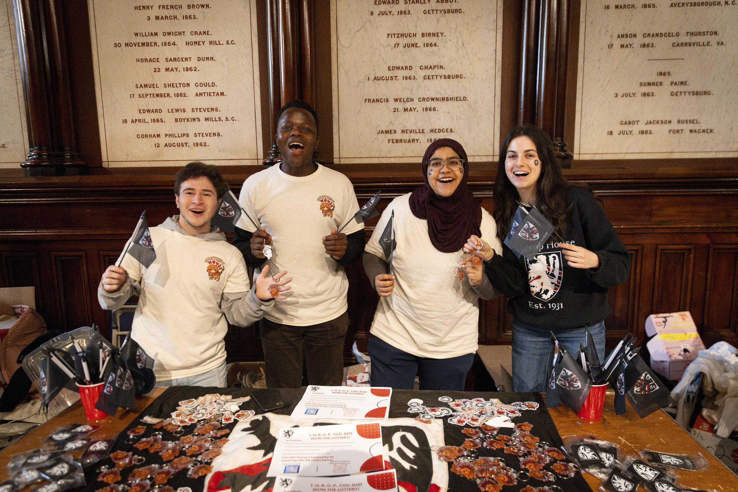 Adrian Guzman ’25 (from left), Nalan Hove ’25, Fatema Abdulla '26, and April Keyes ‘26 show their Winthrop House pride in Annenberg.