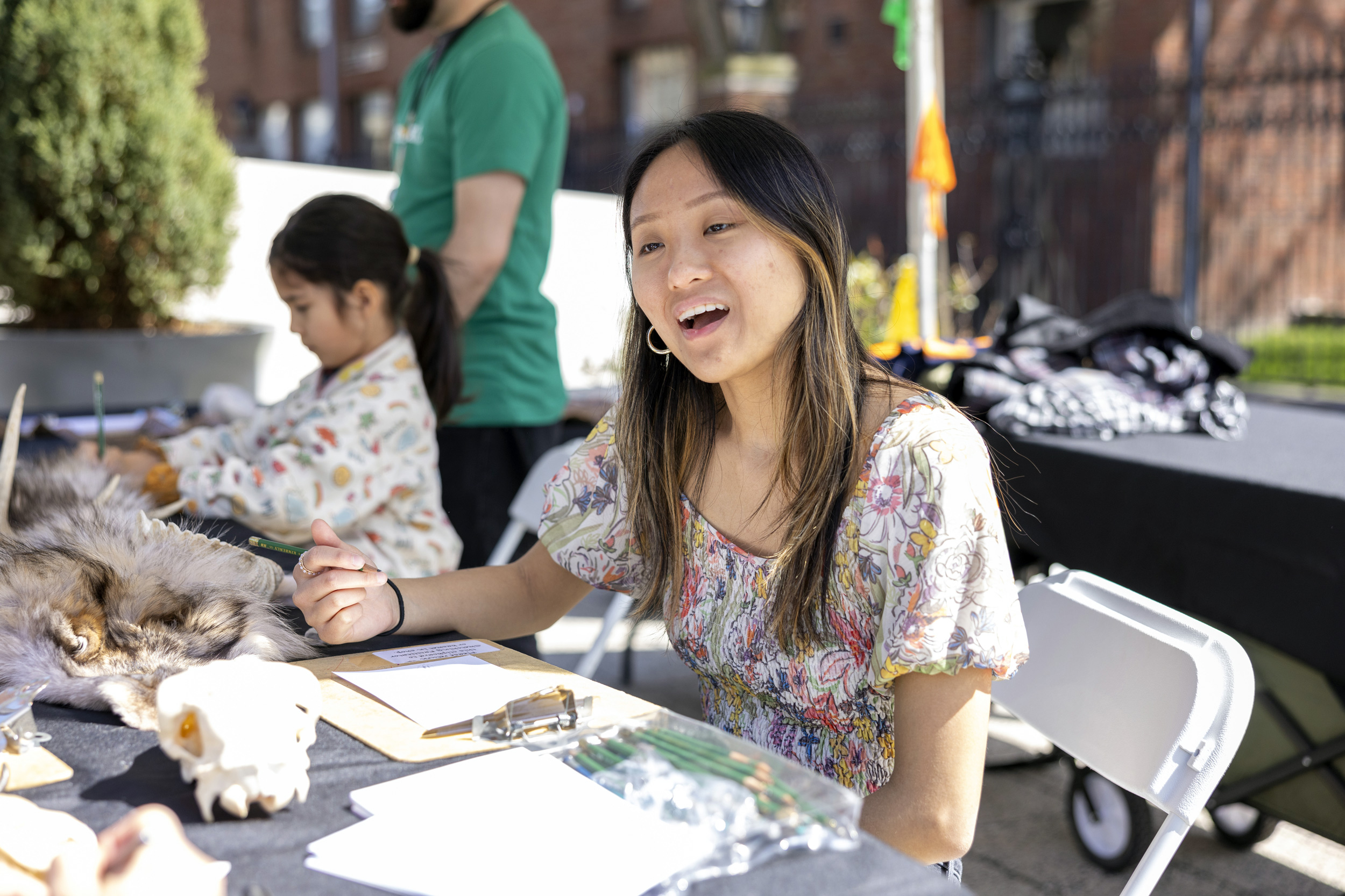 Amy Dange works on a sketch of a specimen at the “Sketch Up Close” tent on Science Center Plaza.