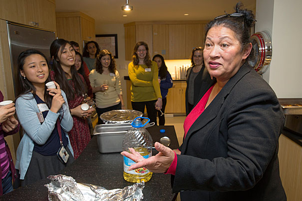 Someone serving food to students