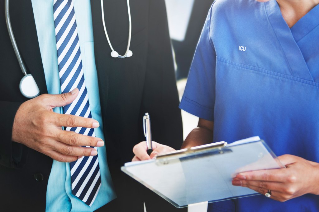 doctor and nurse looking at chart