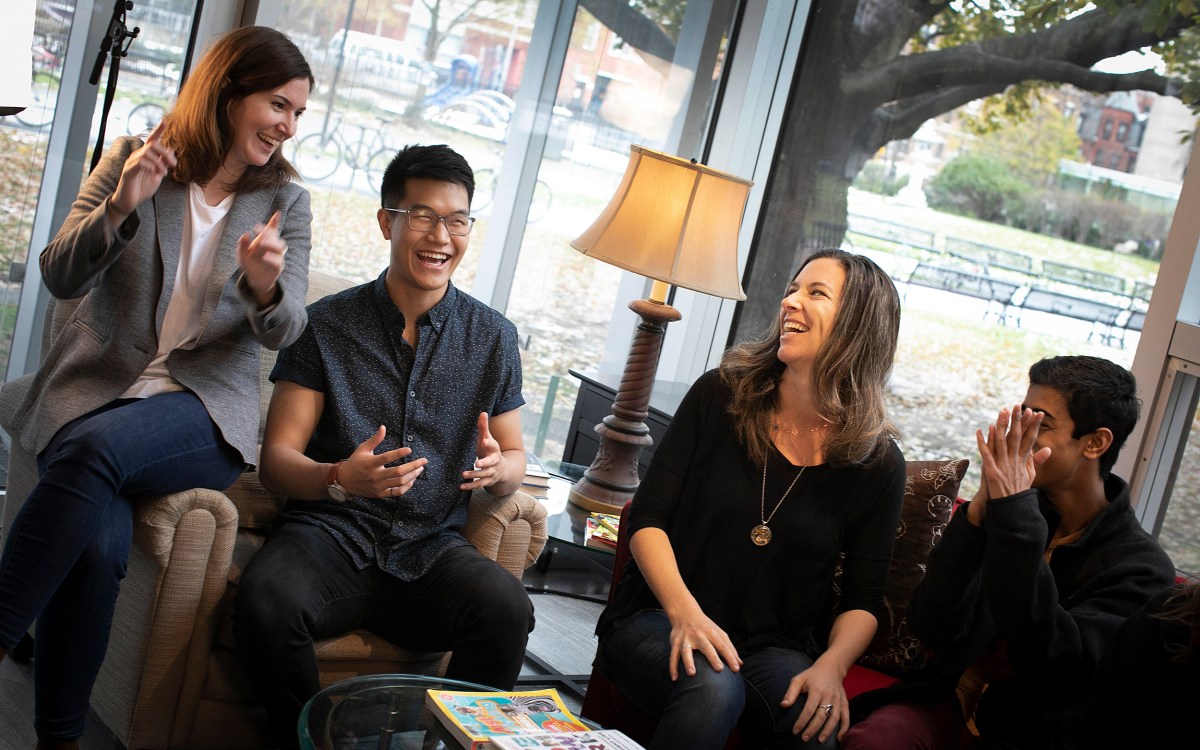 In 'Laughing Room' installation, people sit on couches, laughing.