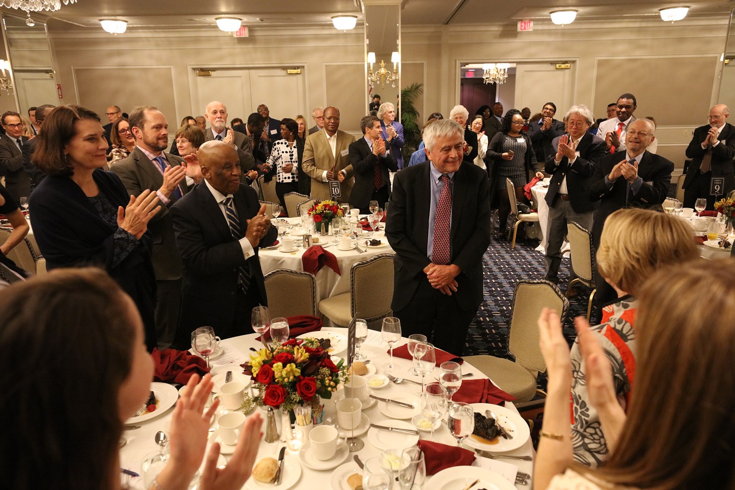 Max Essex surrounded by friends and colleagues at his retirement reception.