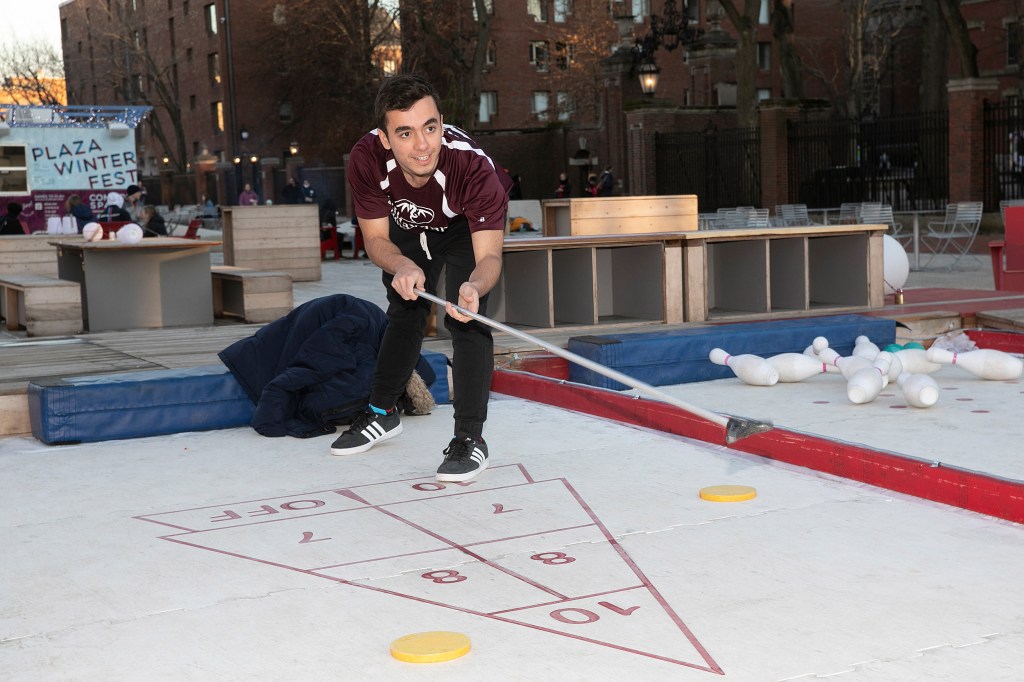 a student playing shuffleboard