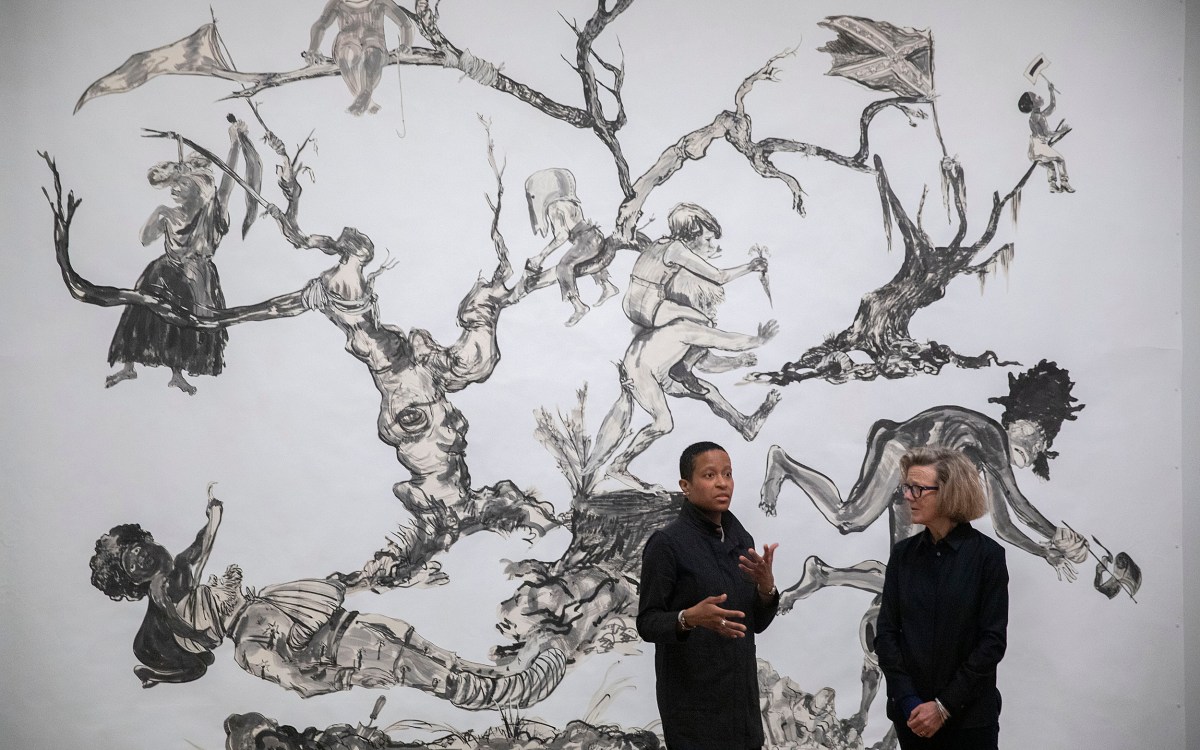 Chassidy Winestock and Mary Schneider Enriquez with Kara Walker's art U.S.A Idioms..