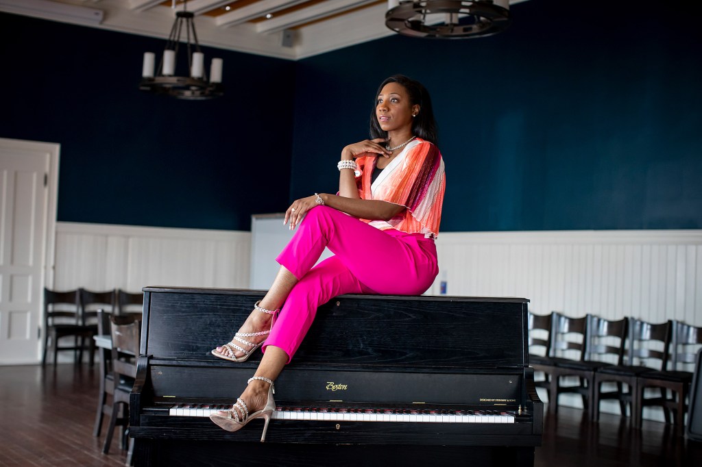 La'Toya sitting on a piano