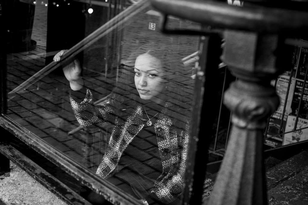 Dominique Erney looking up from behind glass