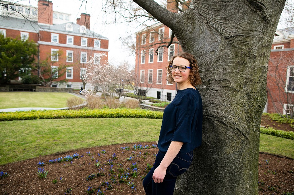 Adele Woodmansee in front of a tree