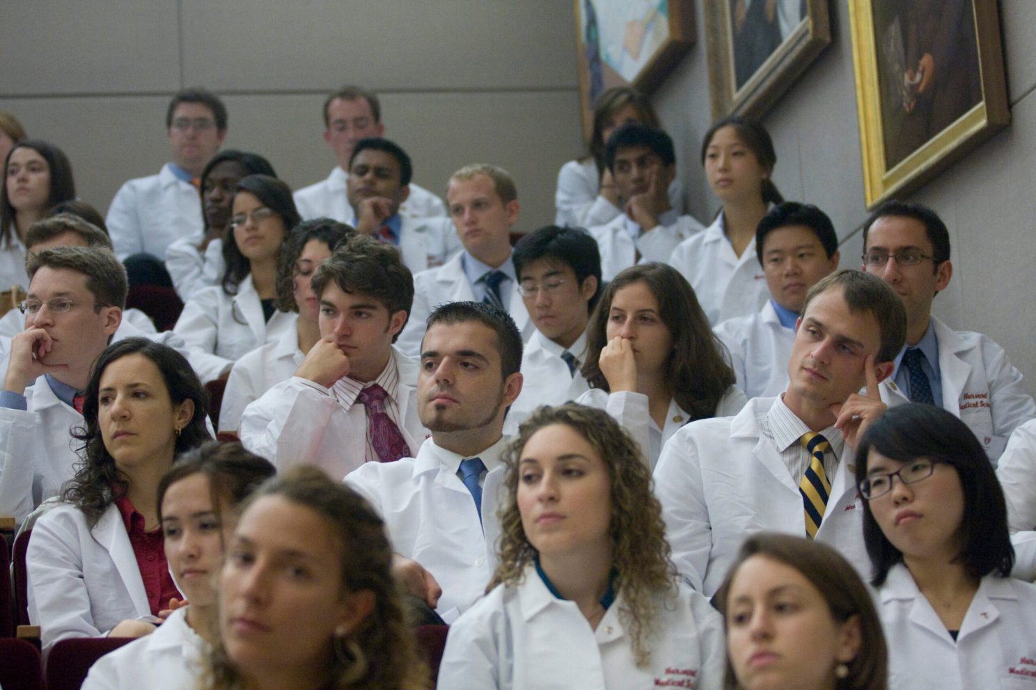 A group of doctors sit in an auditorium