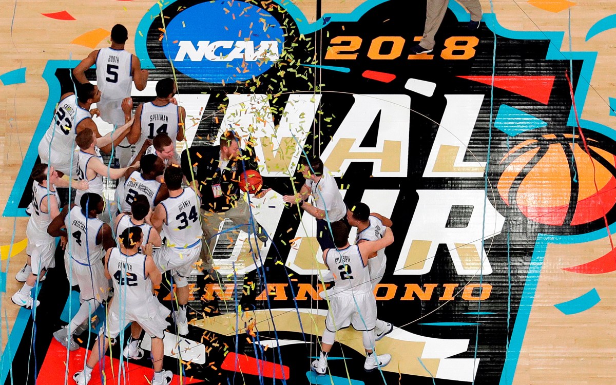 Villanova players celebrate on the basketball court.