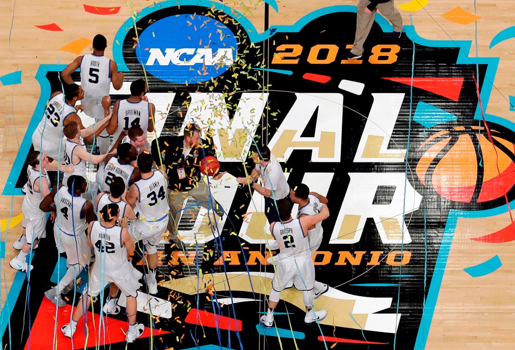 Villanova players celebrate on the basketball court.