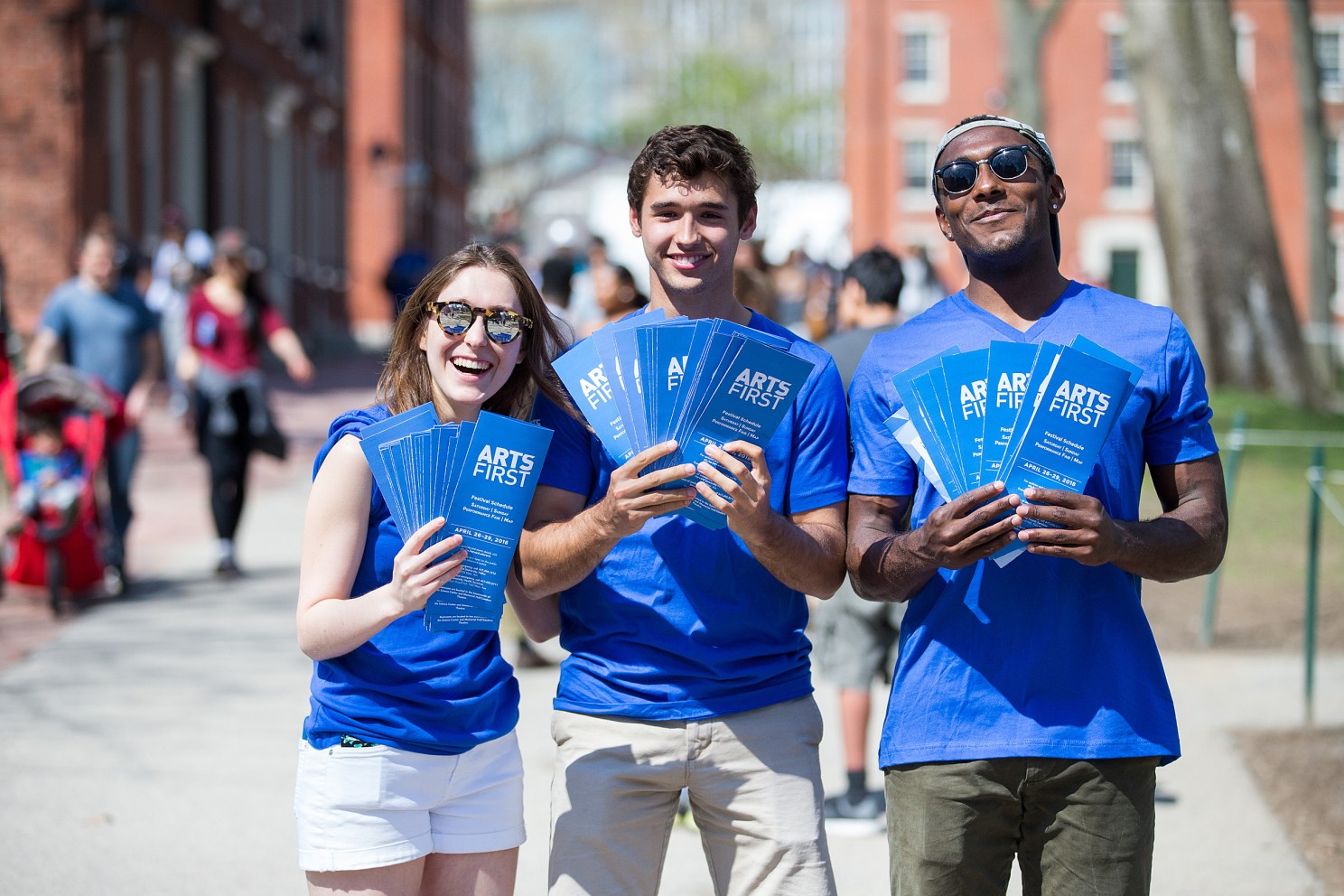 three volunteers holding pamphlets