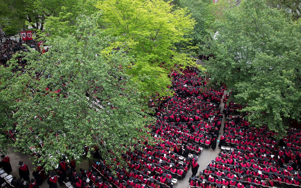 A birds eye view of a sea of Business School Graduates in red robes during Commencement morning exercises