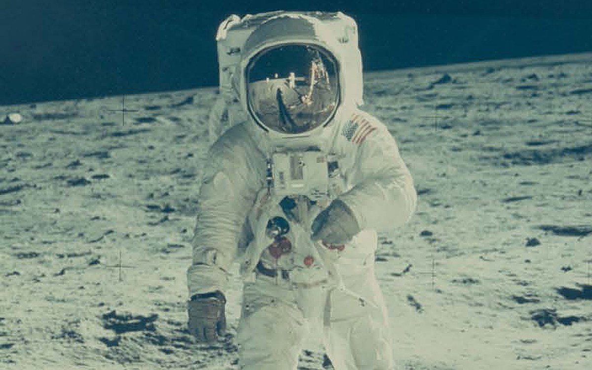 Buzz Aldrin on the moon with Neil Armstrong reflected in his visor.