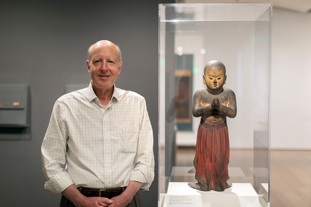 Walter Sedgwick stands next to Japanese statue