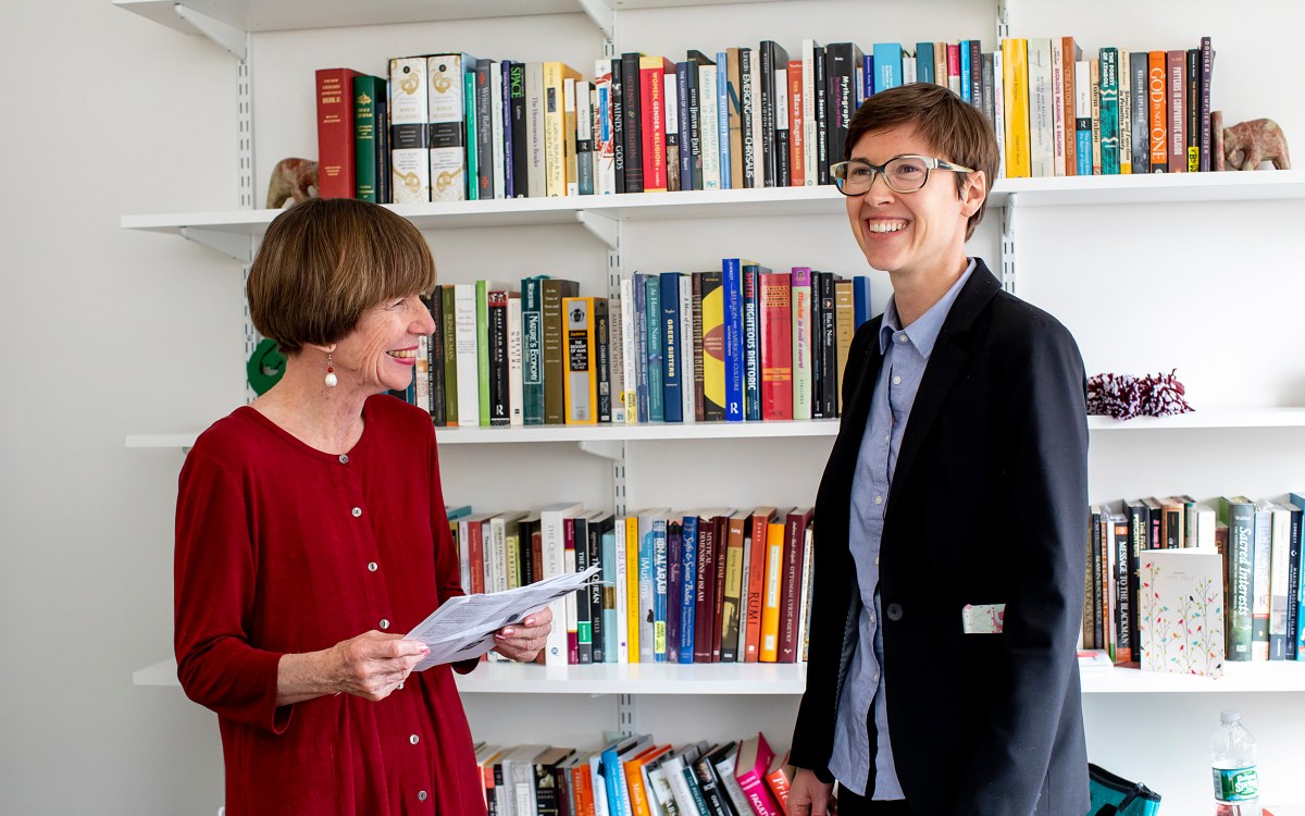 Kathleen Coleman (left) and Eleanor Finnegan chat in front of a bookcase