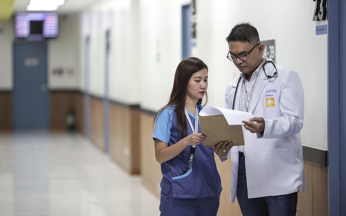 Doctor and assistant looking at a clipboard