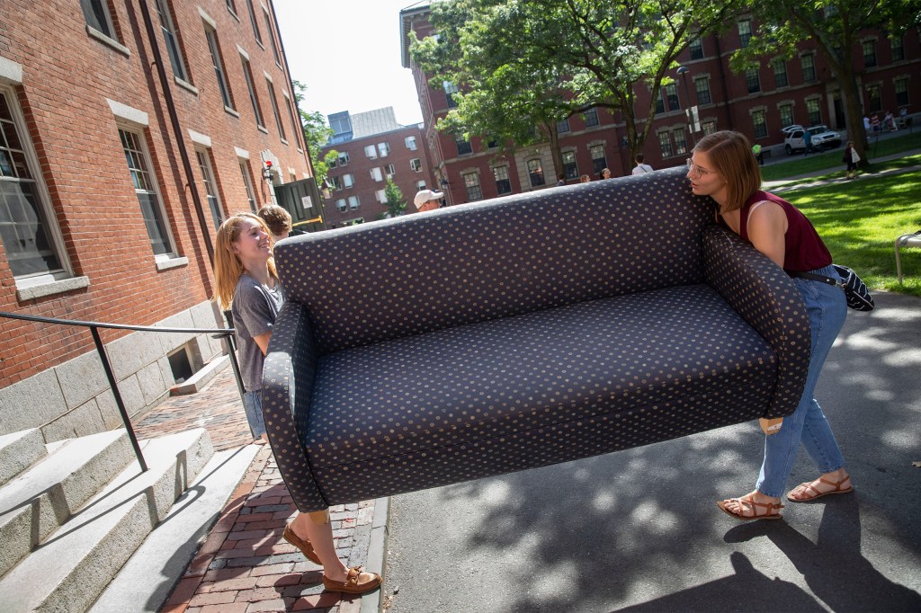 Students carrying a couch