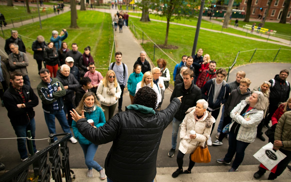 Rachel Gilchrist faces tour group in Harvard Yard.